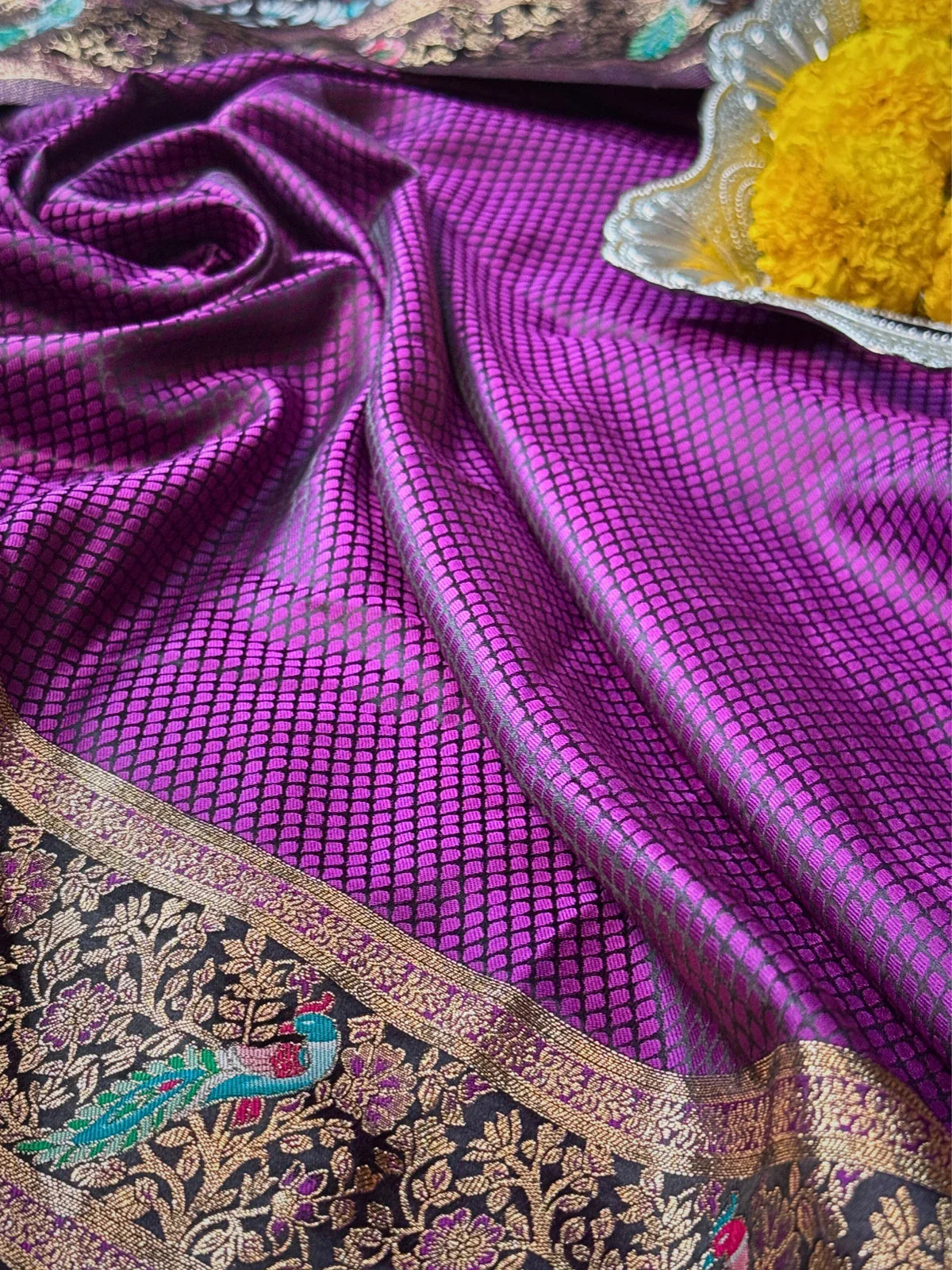 Tarani purple silk saree closeup showing detailed weaving and golden floral zari border