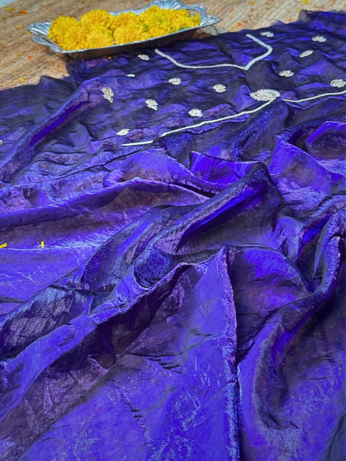 Tarani purple silk saree closeup view highlighting fine fabric shine and intricate design work