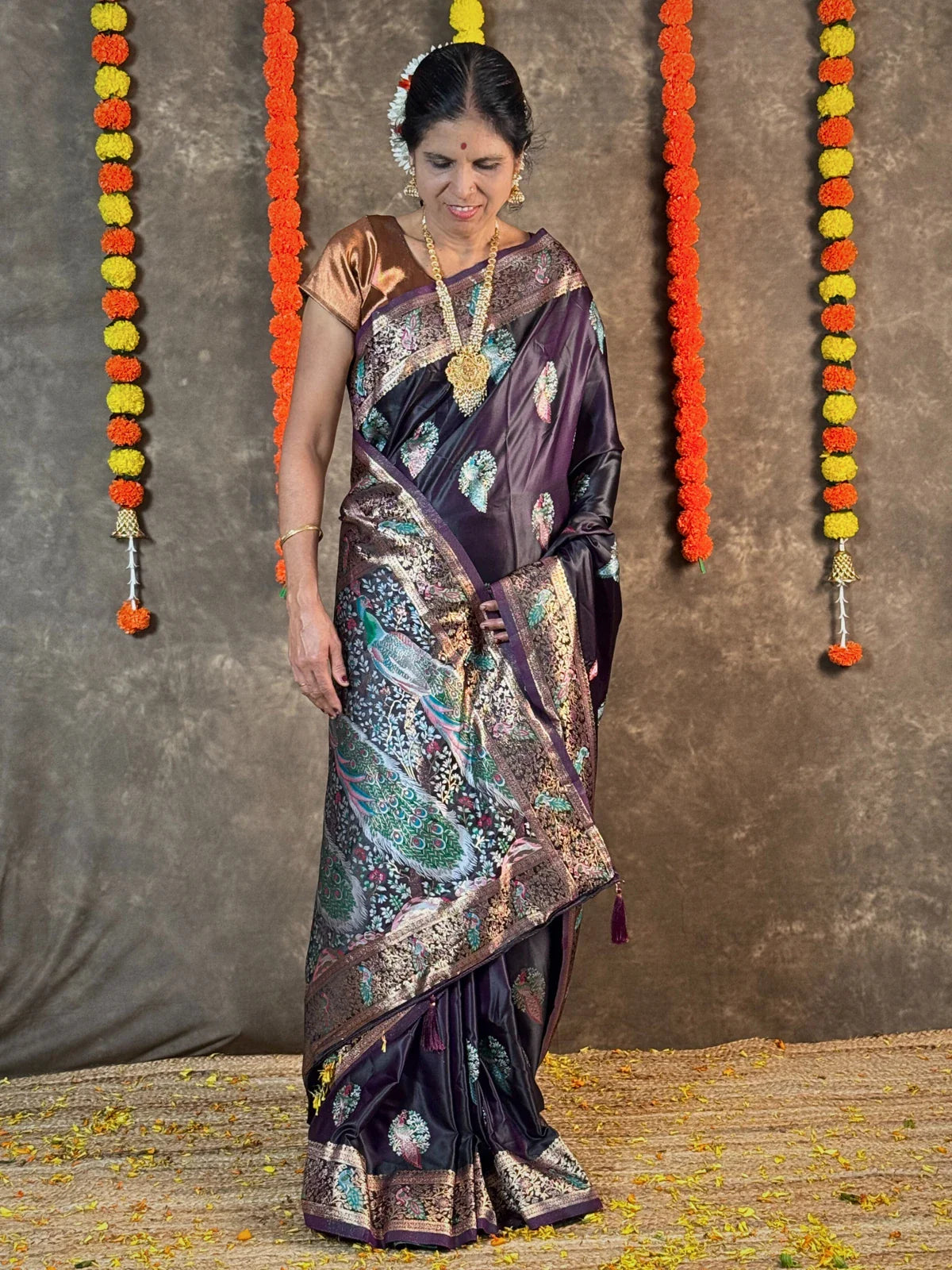 Tarani purple silk saree front view styled with traditional jewellery and festive decor