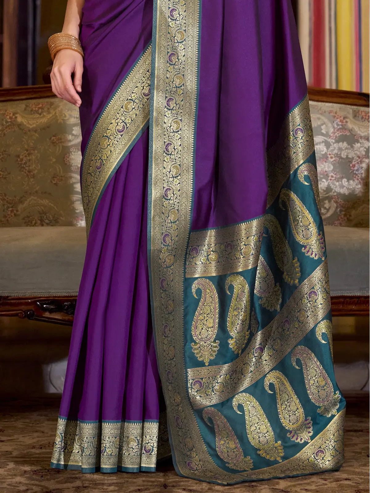Tarani purple silk saree pallu closeup showing teal design with golden paisley motifs