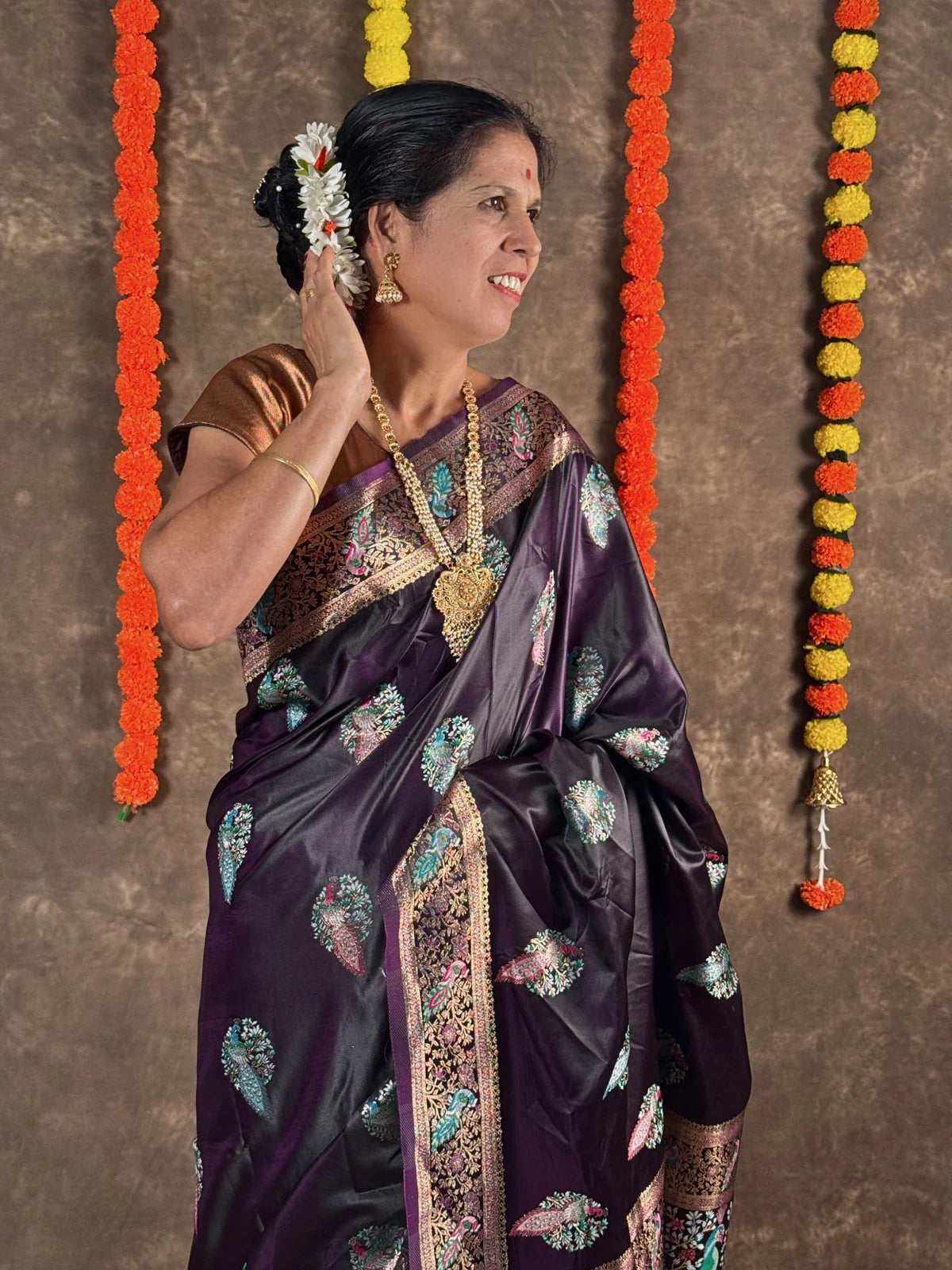 Tarani purple silk saree upper body view with elegant golden blouse and floral motifs