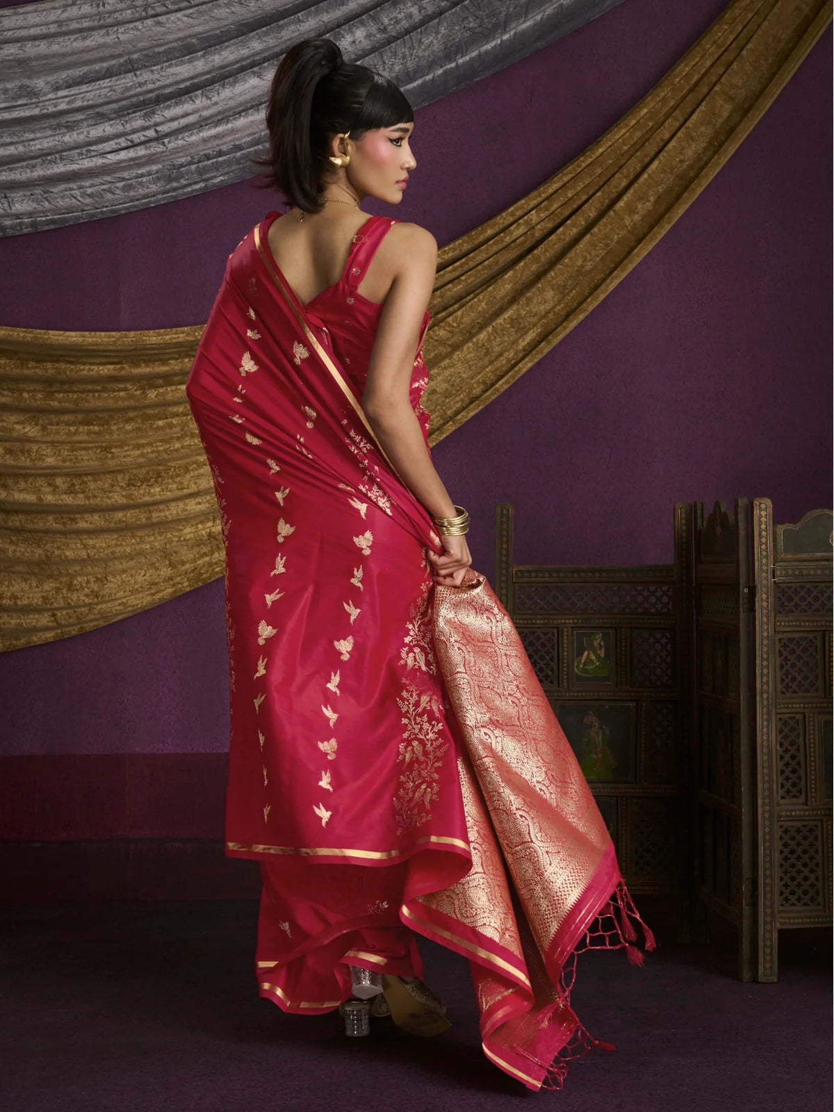 Tarani red silk saree back view showing drape and bird pattern work with soft texture