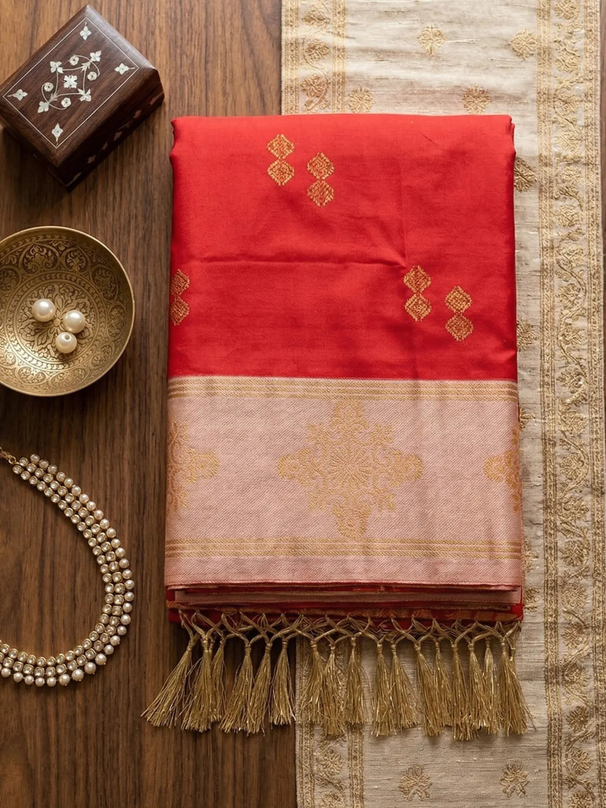 Tarani red soft silk saree folded closeup with zari border and tassel pallu detailing