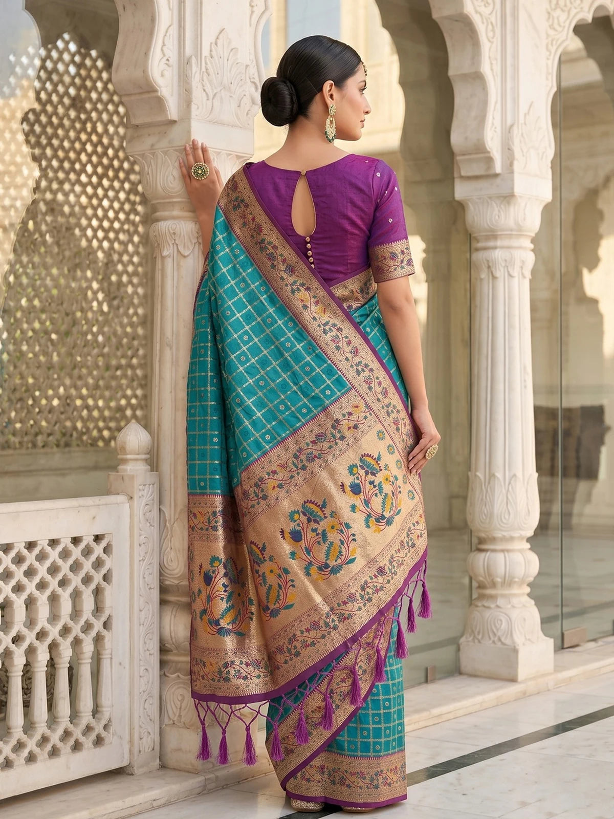 Tarani Banarasi silk teal saree back view with elegant floral pallu and zari work