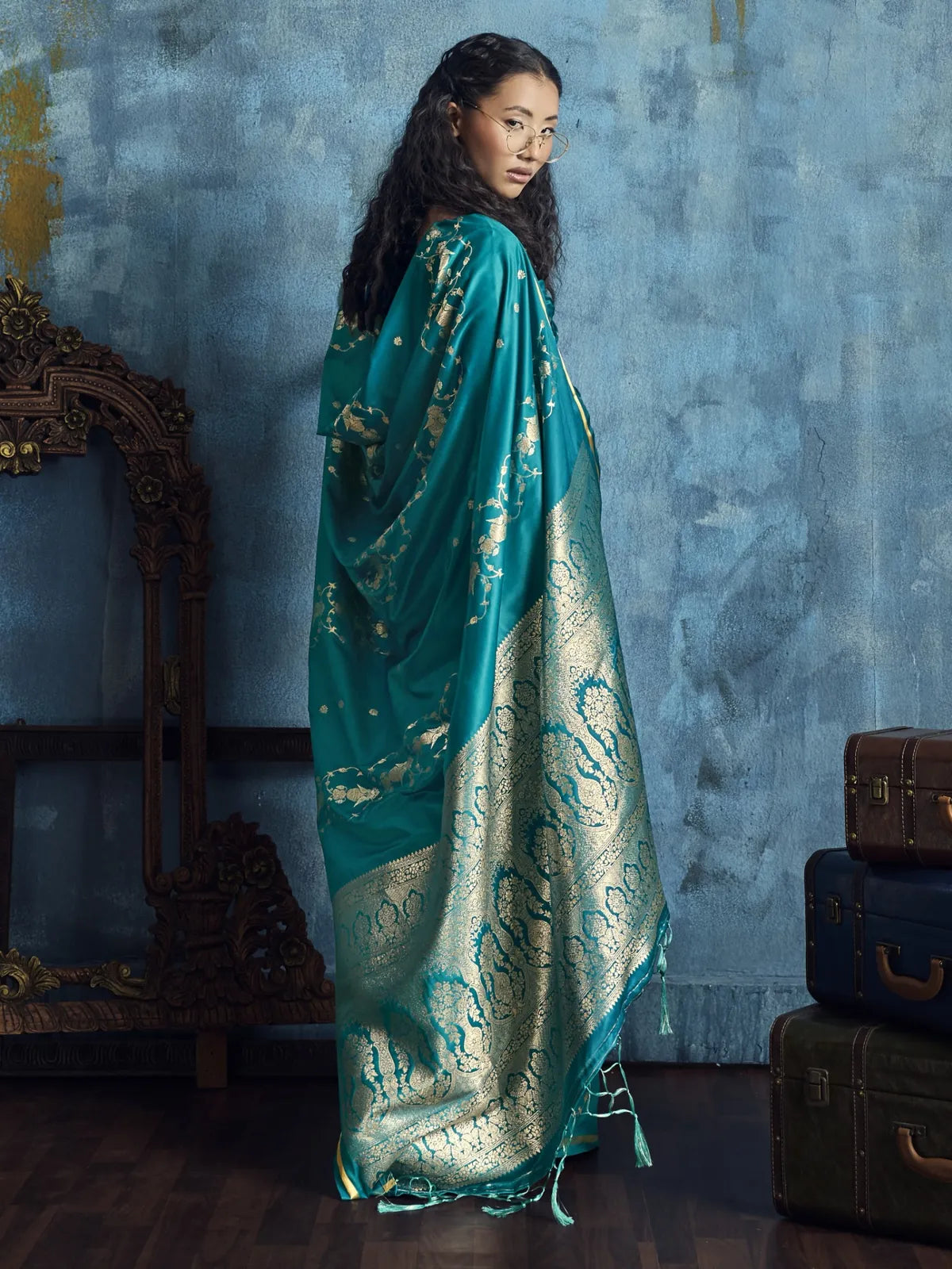 Tarani Dayita teal satin saree back view featuring grand woven pallu and decorative border