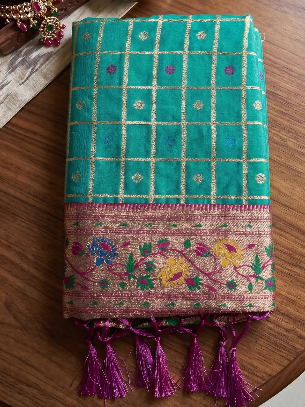 Tarani Yutika Banarasi silk saree fabric closeup with zari checks and floral border