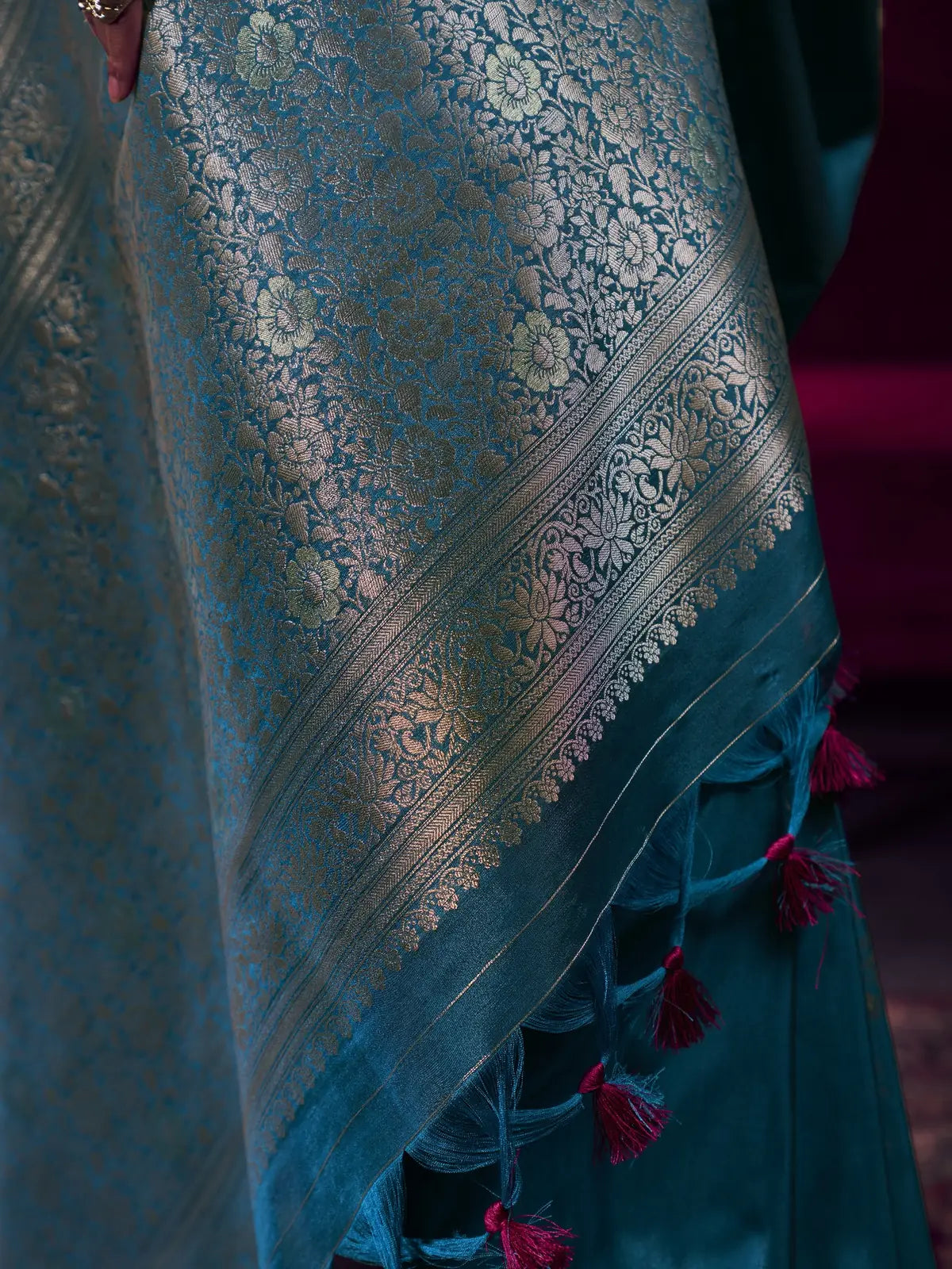 Tarani teal satin linen silk saree closeup view with intricate zari border detailing