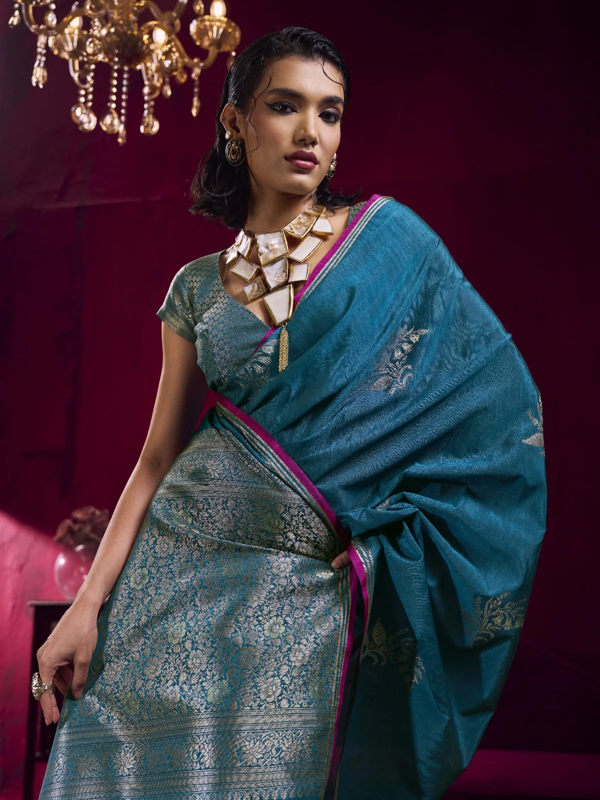 Tarani teal woven silk saree front view with rich zari pallu and festive styling