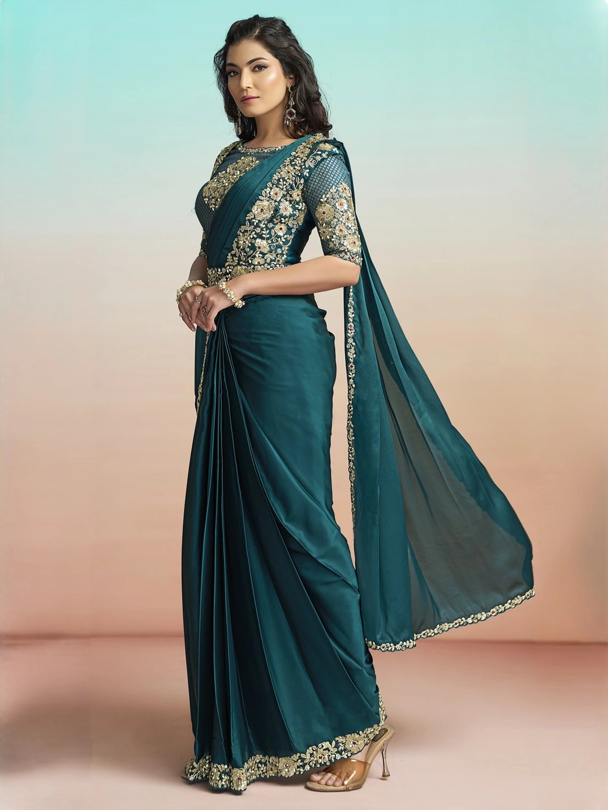 Tarani Shreeya teal lustrous silk saree side view with floral embellished border and flowing pallu