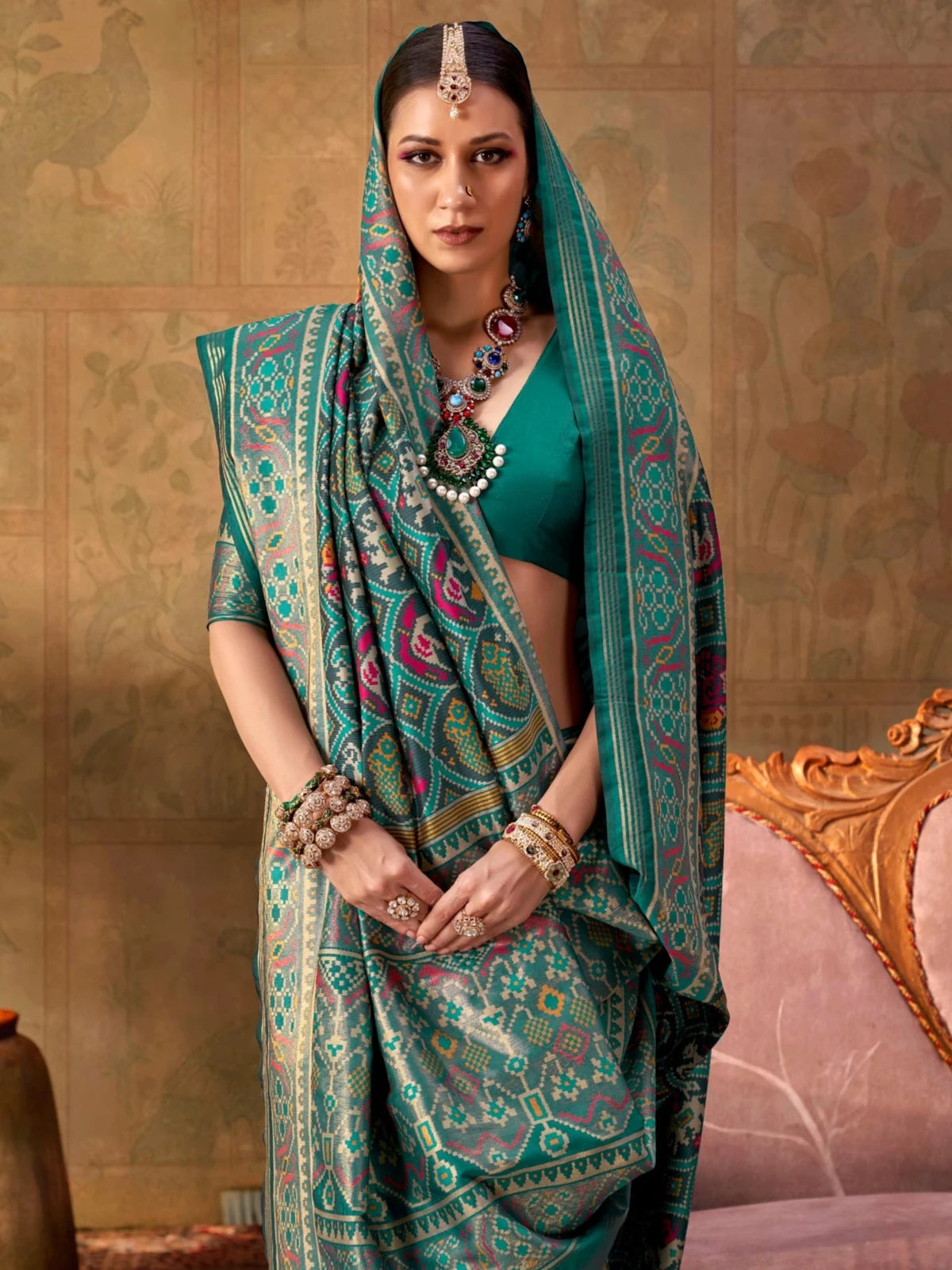 Tarani teal silk Patola saree upper body view highlighting border and blouse