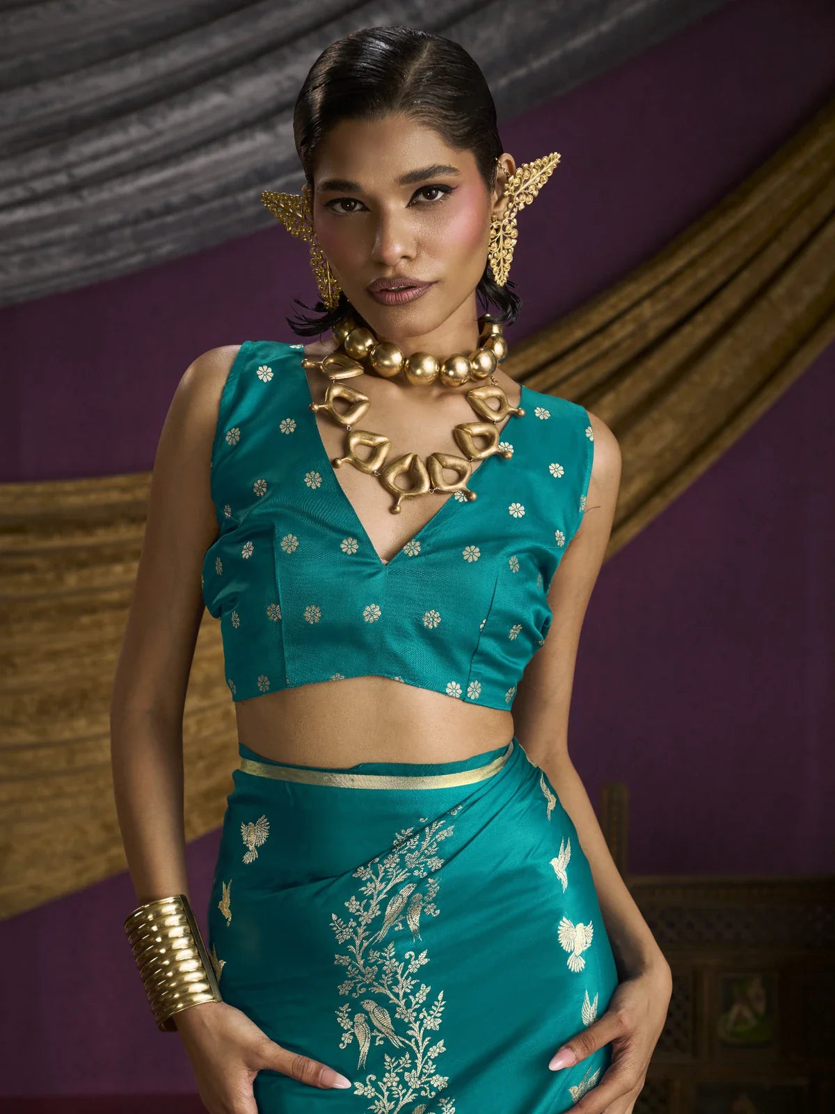 Tarani close-up of blouse and upper drape in teal satin silk with zari bird motifs