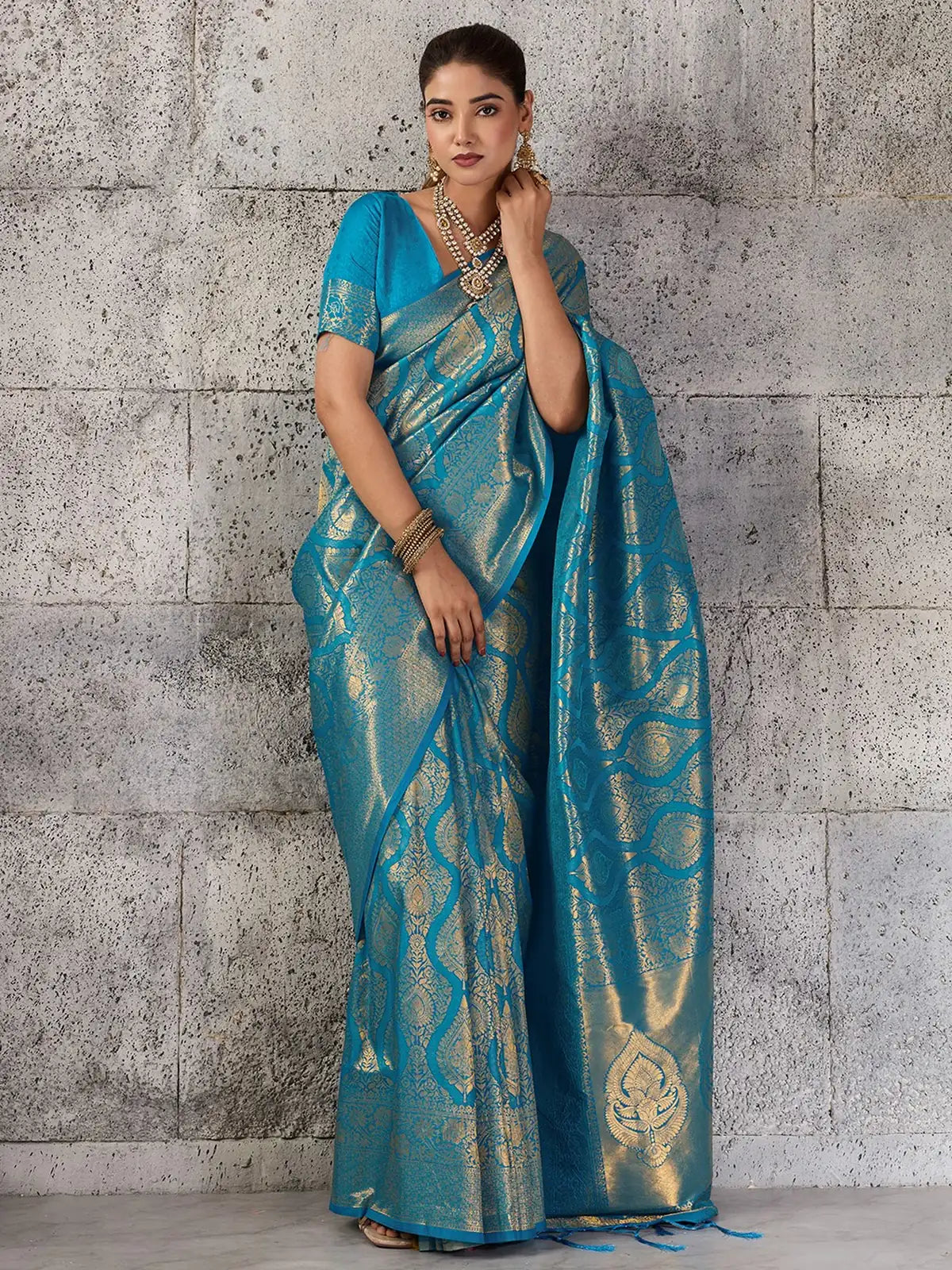 Tarani turquoise blue Kanjivaram silk blend saree graceful full pose with woven zari design