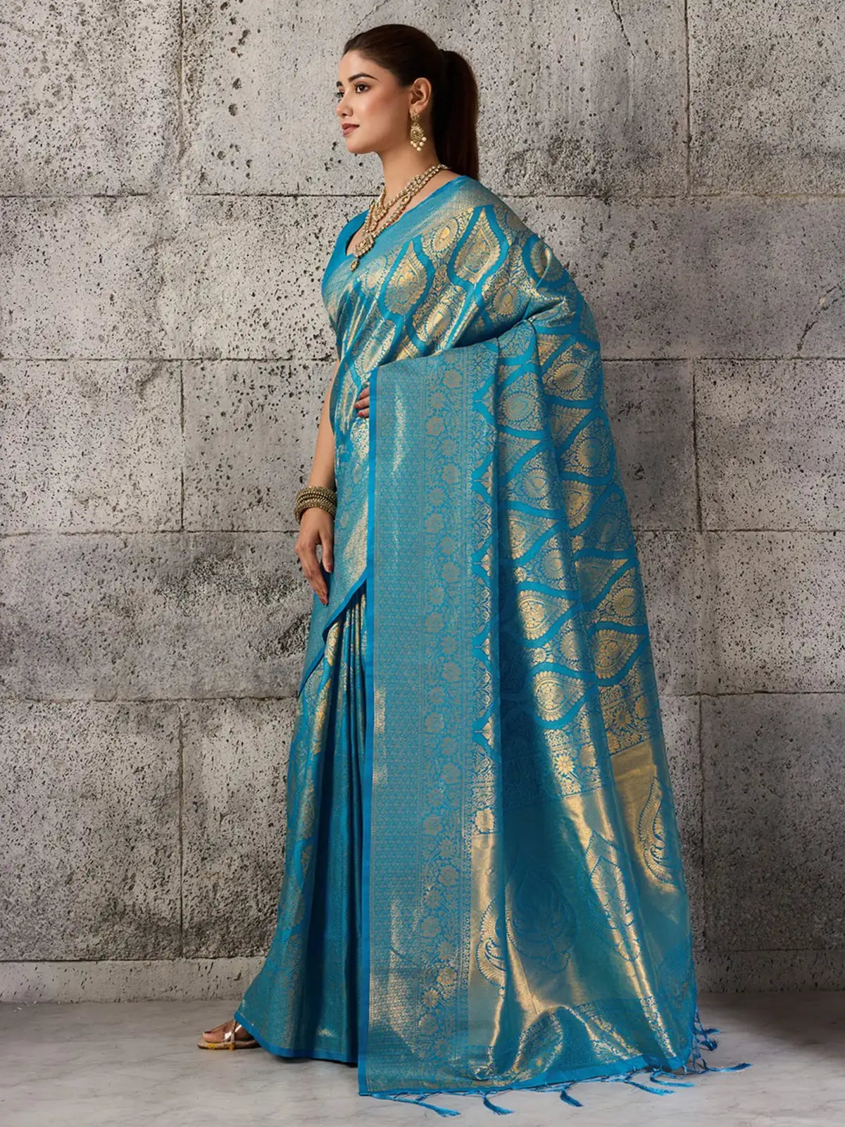 Tarani turquoise blue Kanjivaram silk blend saree side pose showcasing zari pallu