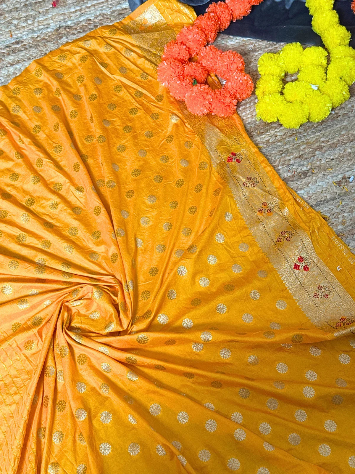 Tarani yellow silk saree closeup view showing woven floral and zari motifs