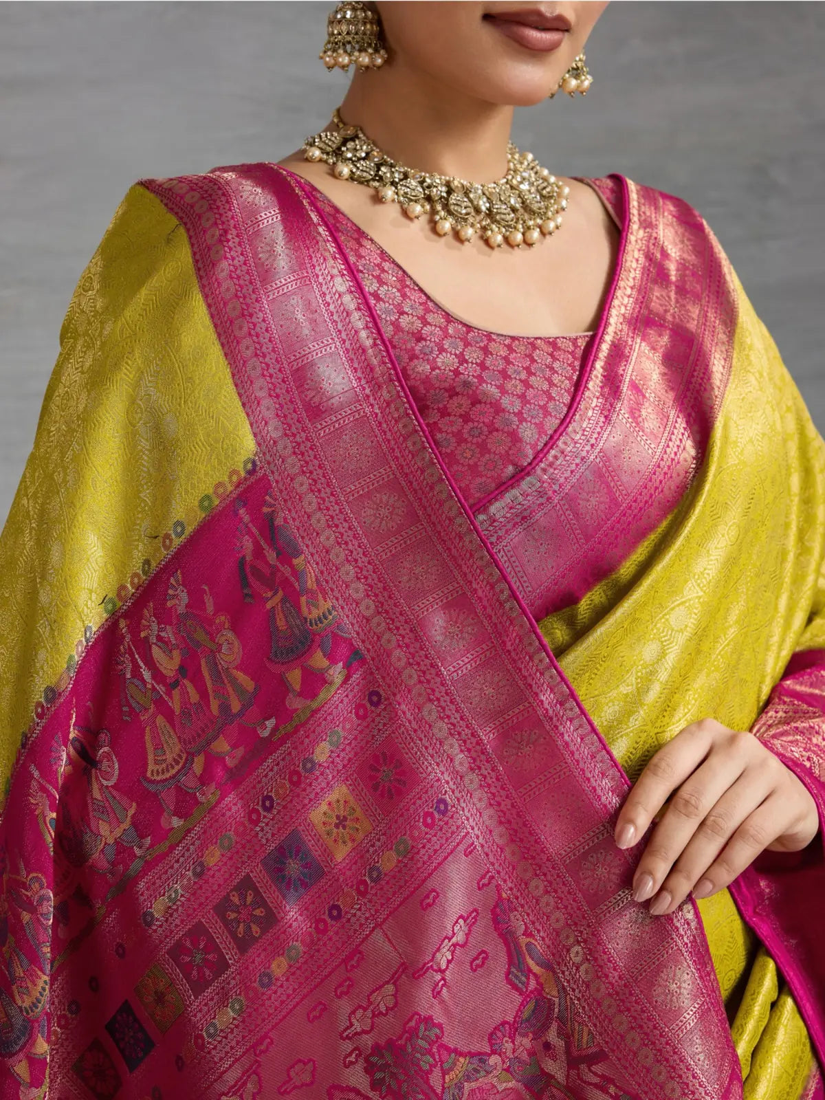 Tarani yellow silk saree closeup showing zari weaving and meenakari pallu details