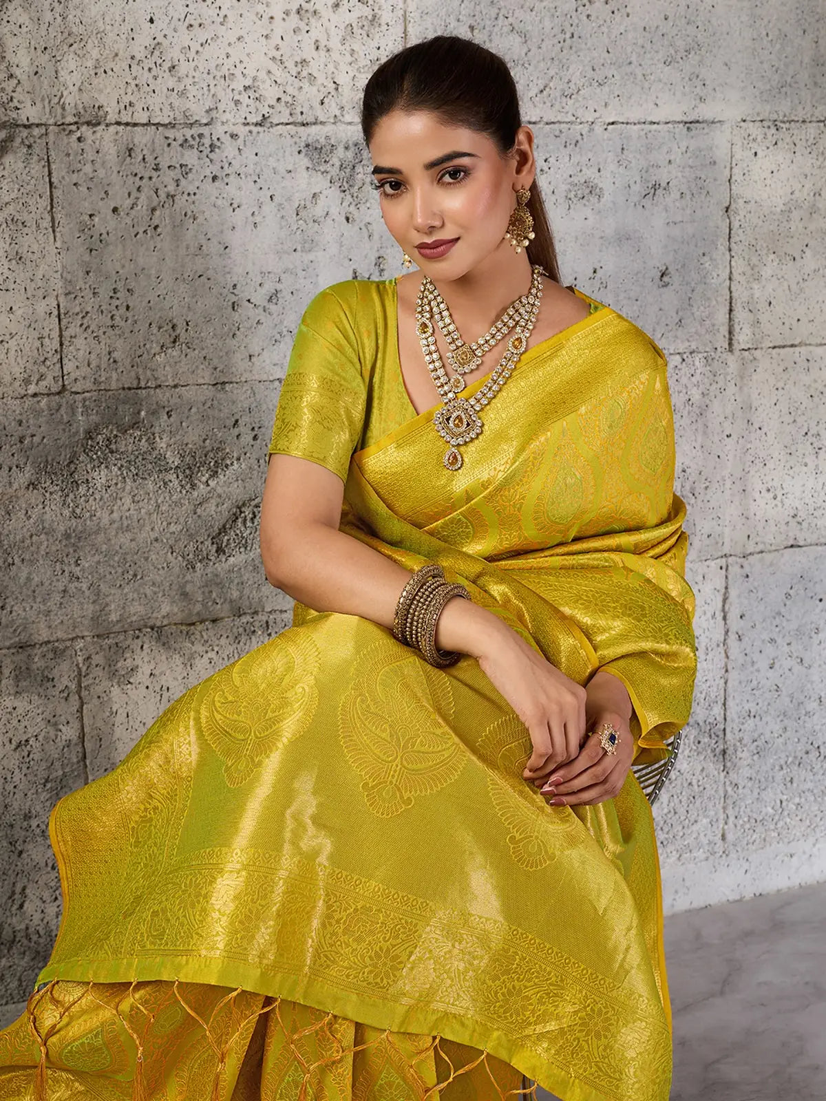 Tarani Rajvika yellow Kanjivaram silk blend saree seated front pose with woven zari motifs