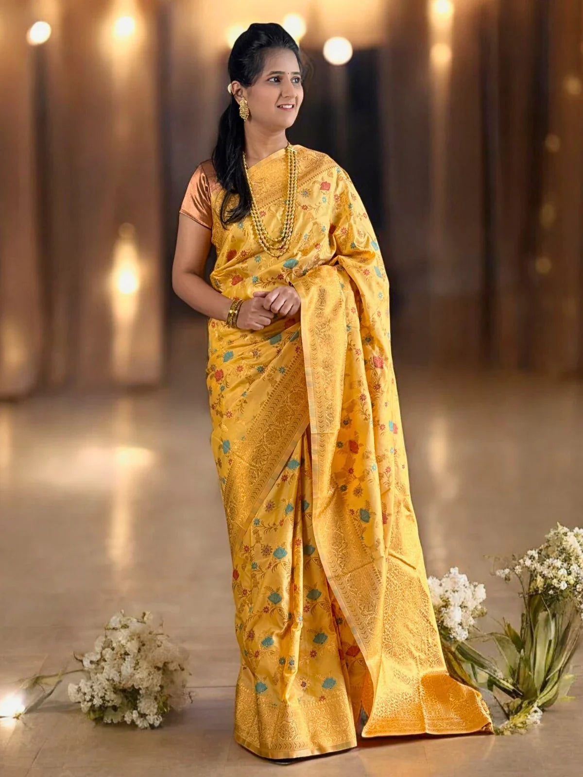 Tarani yellow silk saree full view with zari border and floral motifs