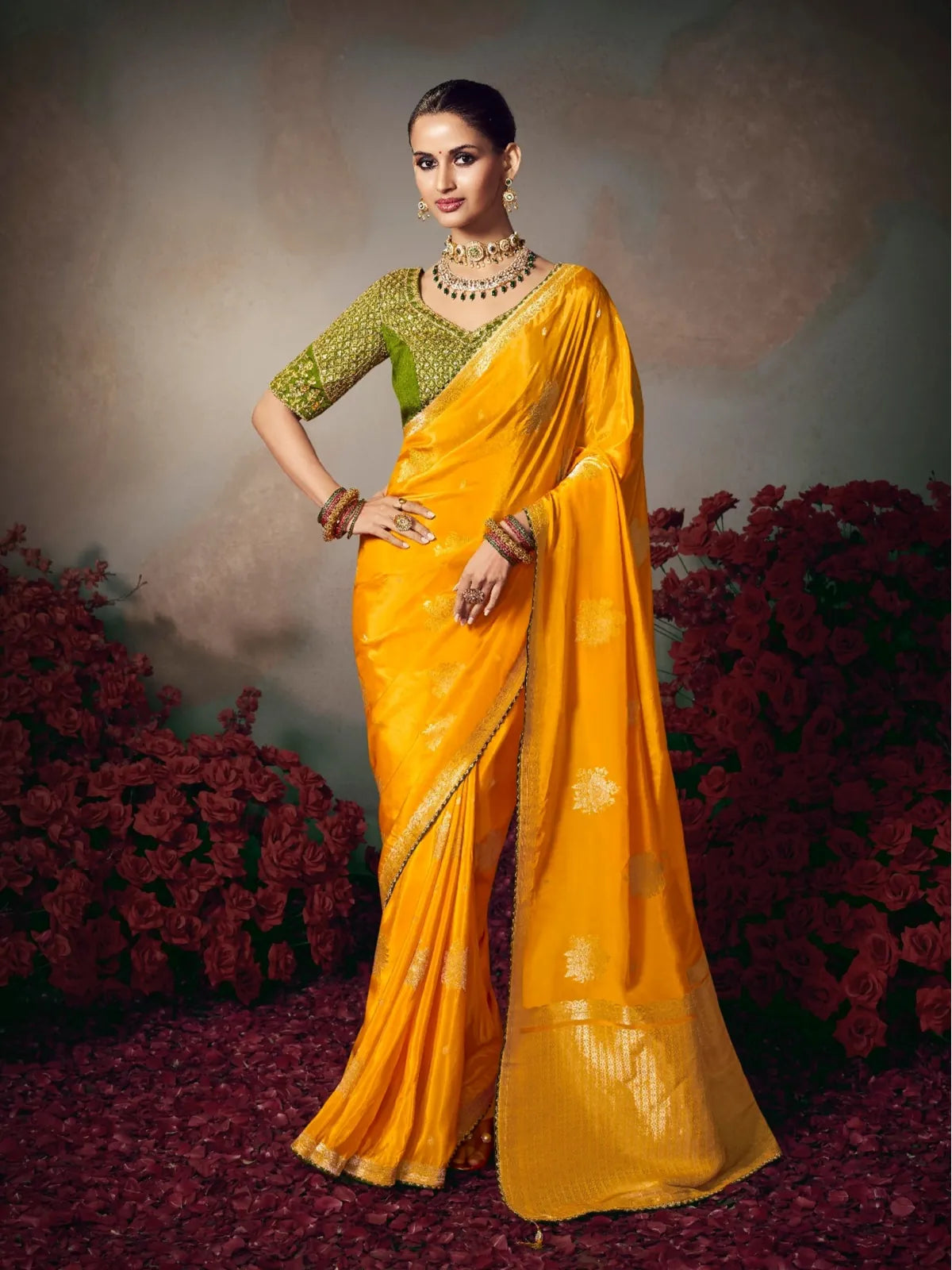 Tarani yellow silk saree full view with golden motifs and green embroidered blouse