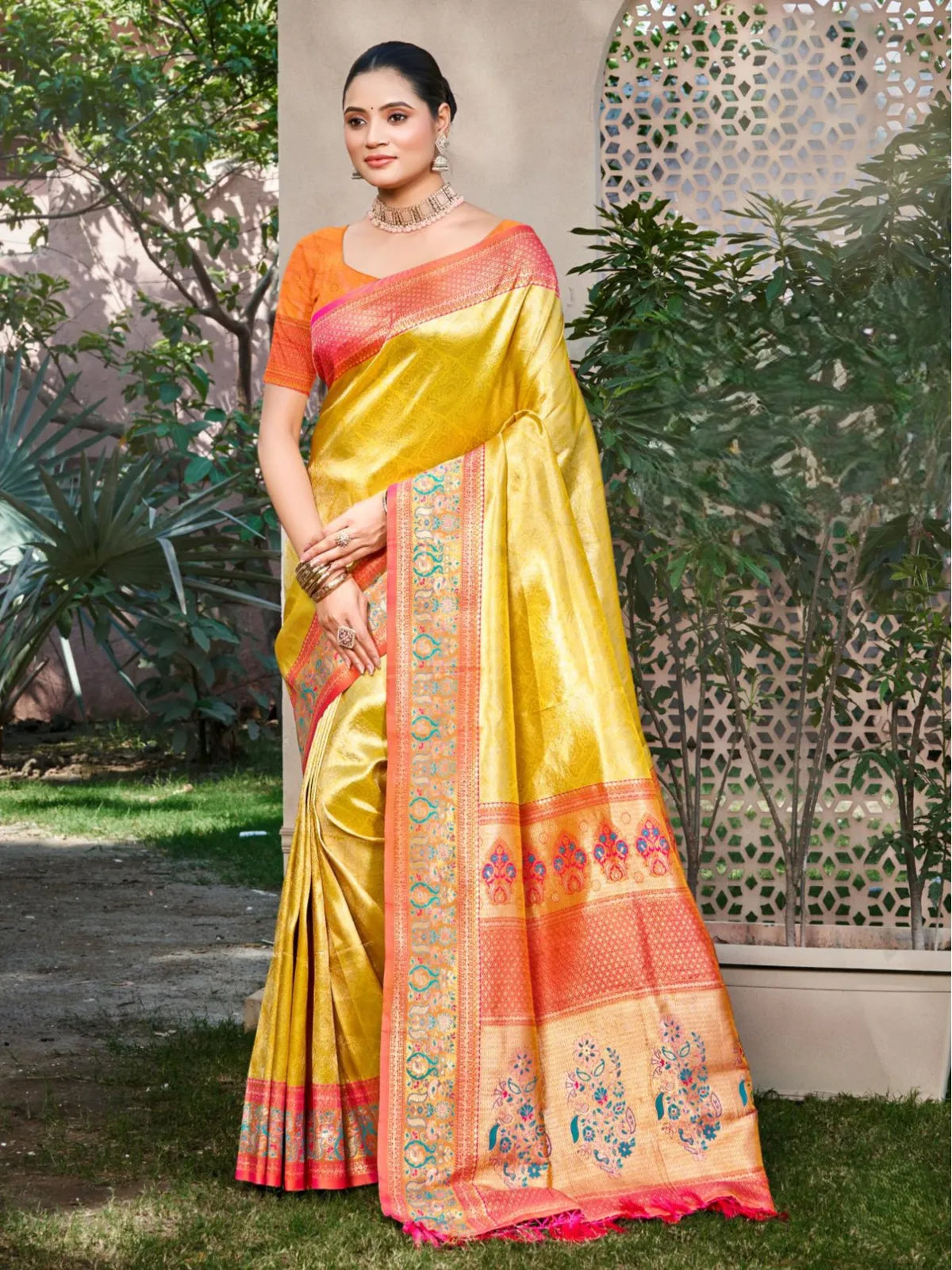 Tarani yellow kanjivaram silk festive saree with coral pink pallu and traditional motifs