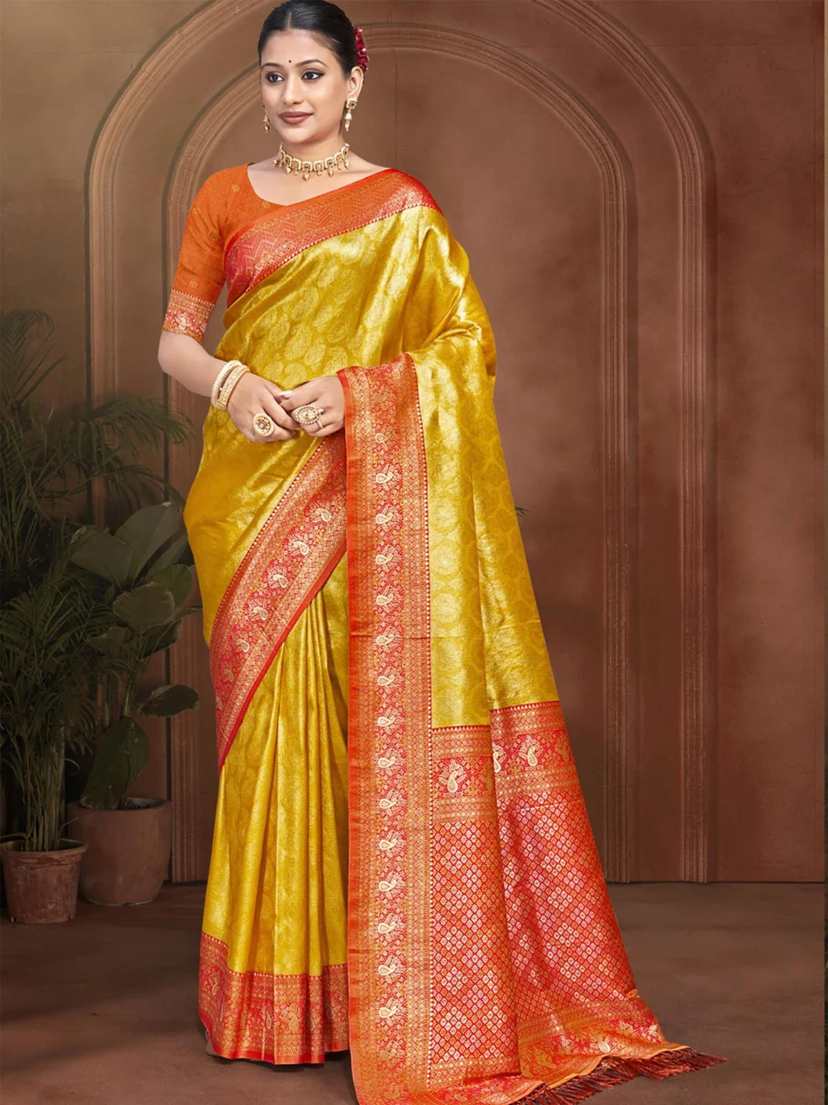 Tarani yellow Kanjivaram silk saree full view with red zari border for festive occasions