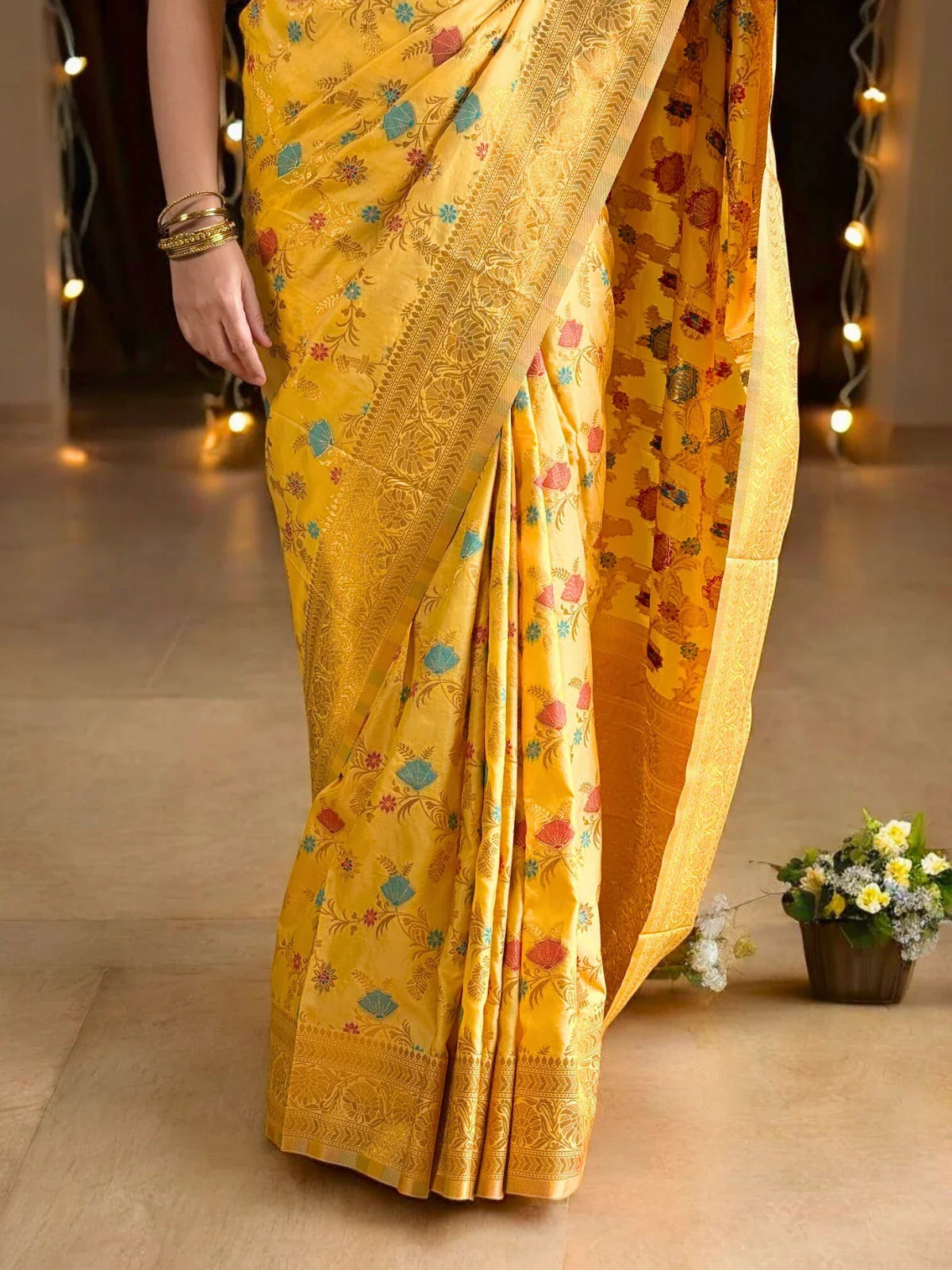 Tarani yellow silk saree pallu view with golden border and motifs