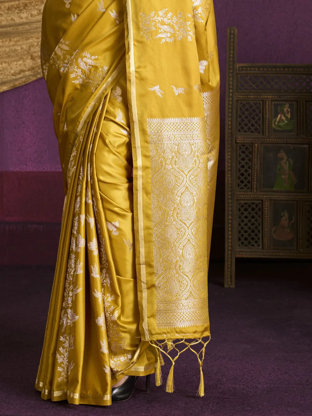 Tarani yellow saree pallu view with intricate border design and tassel detailing