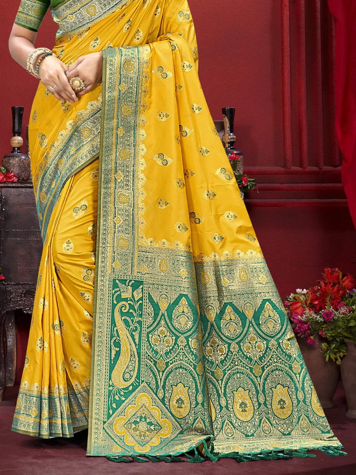 Tarani yellow silk saree pallu view with intricate golden zari and green detailing