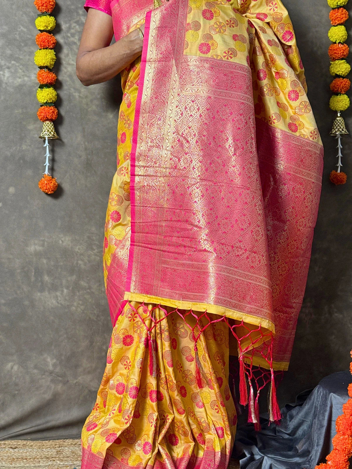 Tarani yellow silk saree with woven motifs and pink border front view for weddings