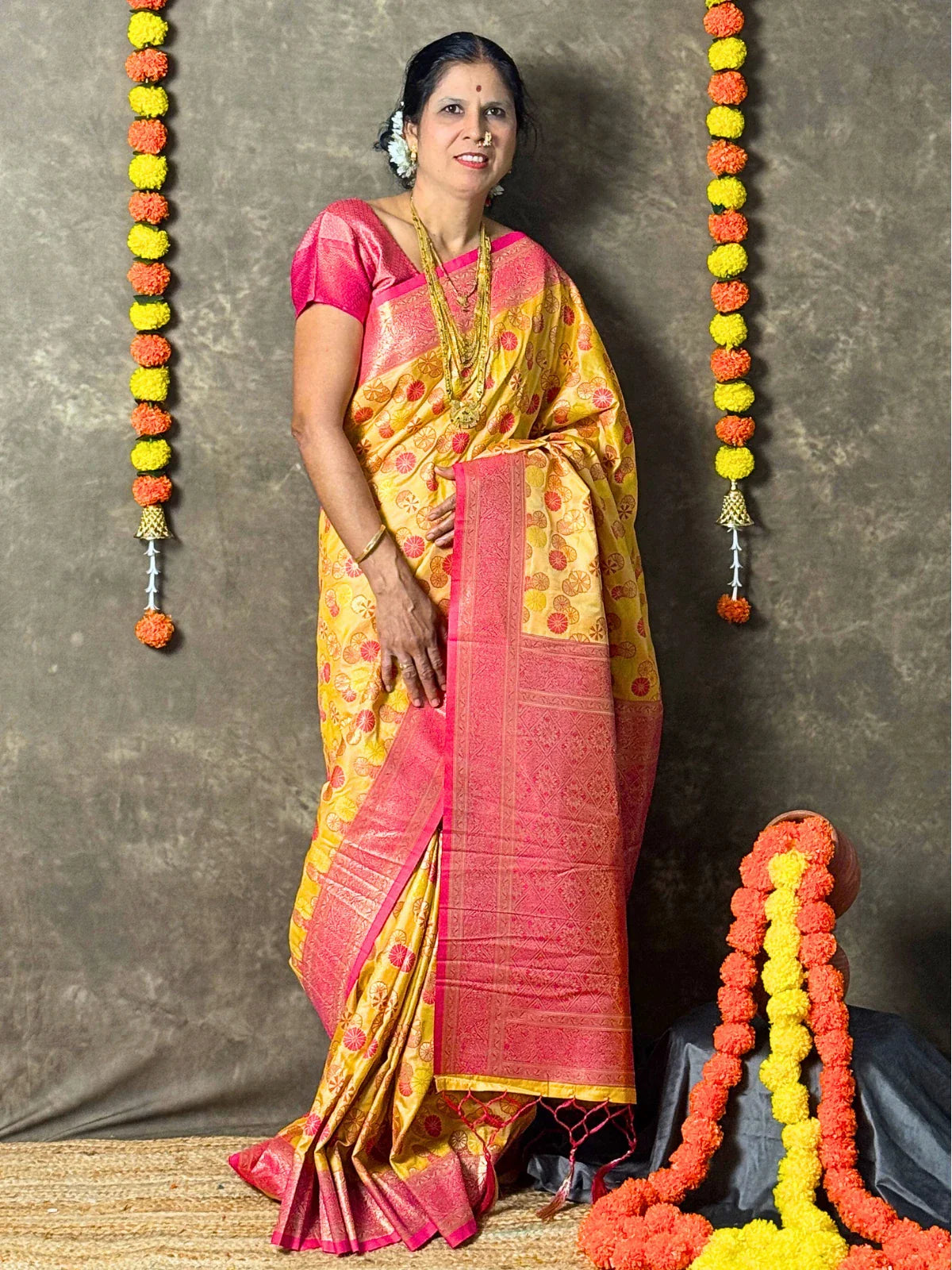 Tarani yellow silk saree with intricate woven pink pallu and zari detailing