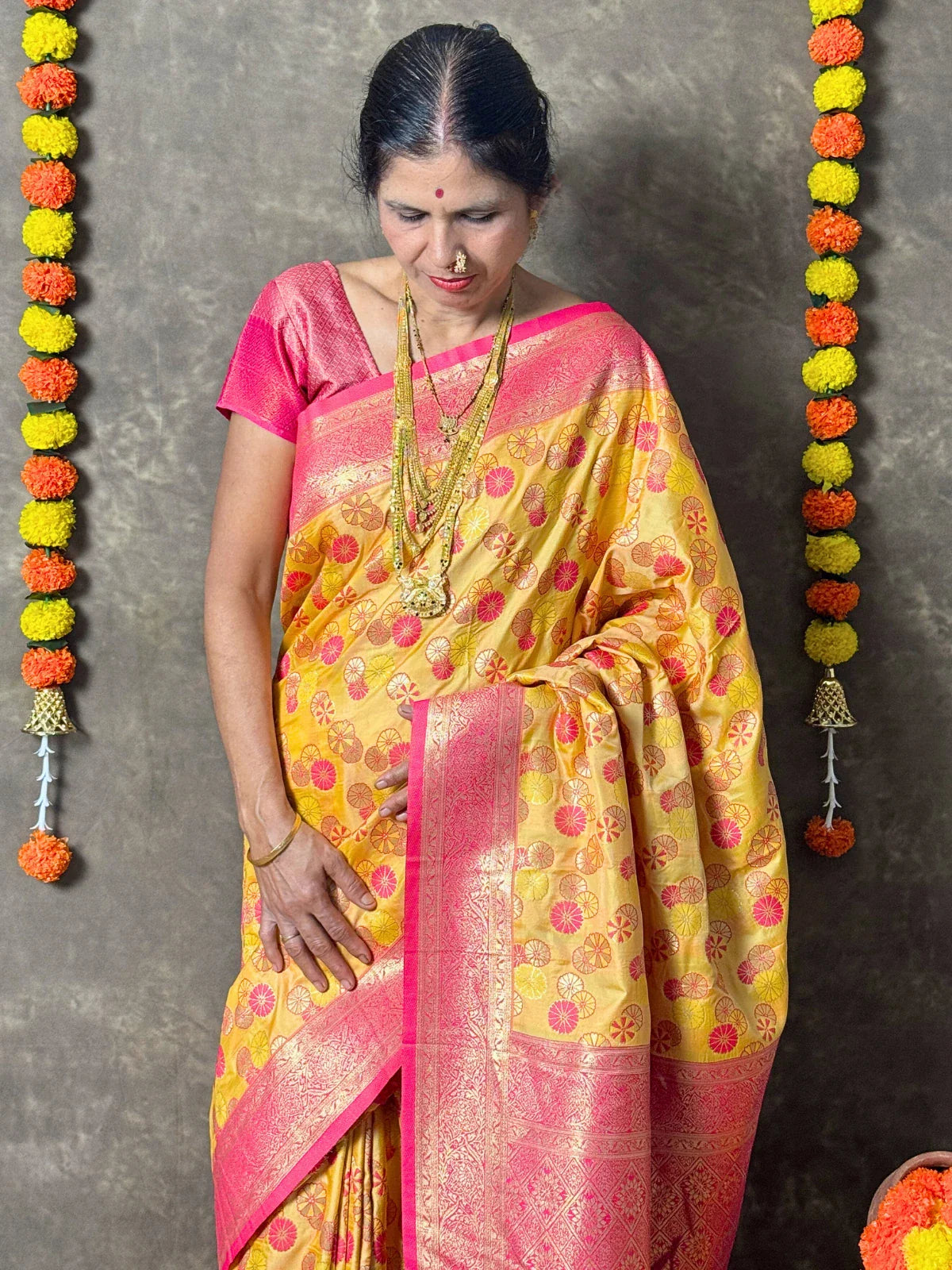 Tarani yellow silk saree with pink border upper body view highlighting blouse style