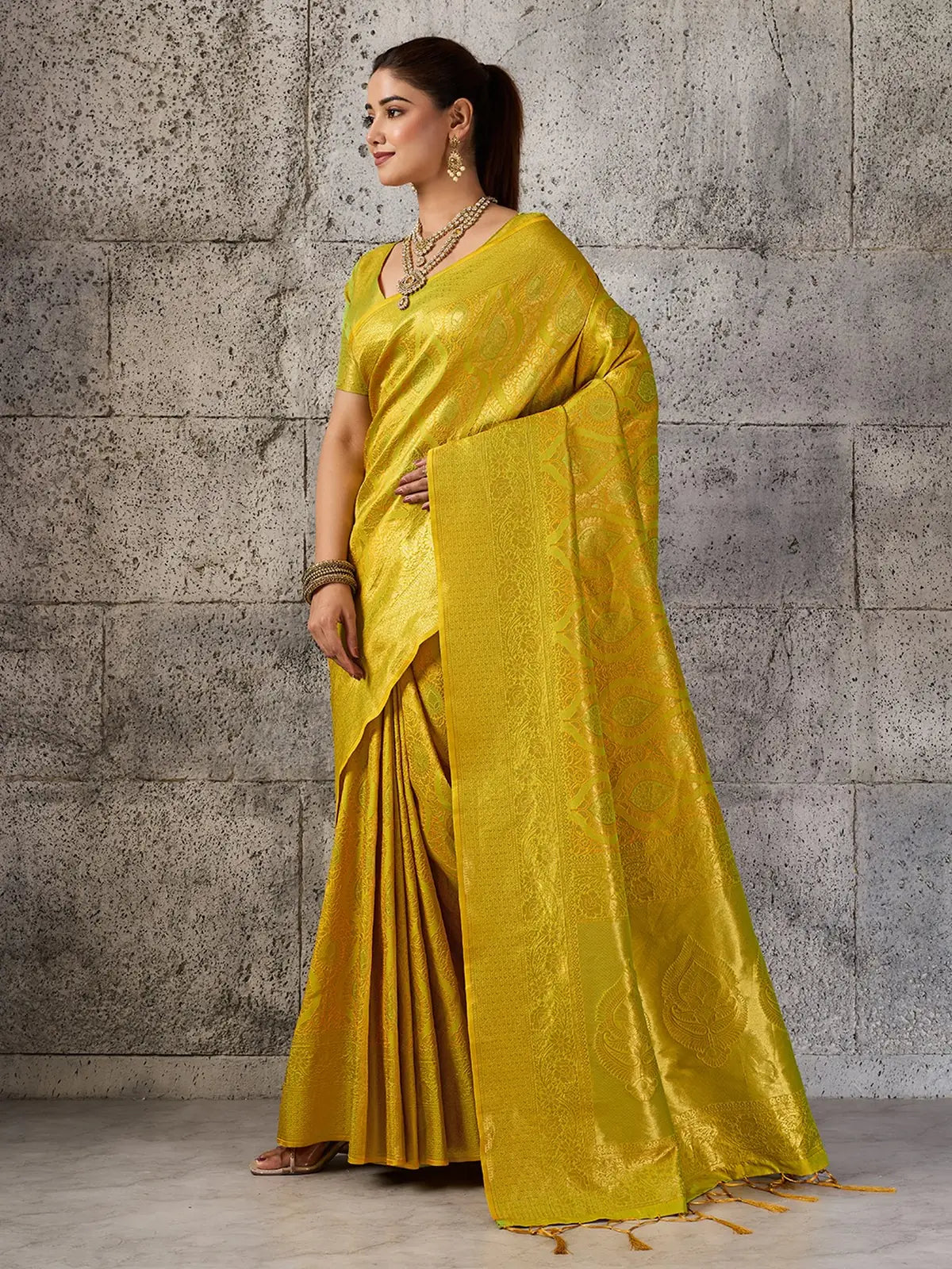 Tarani Rajvika yellow Kanjivaram silk blend saree elegant side view with rich zari pallu