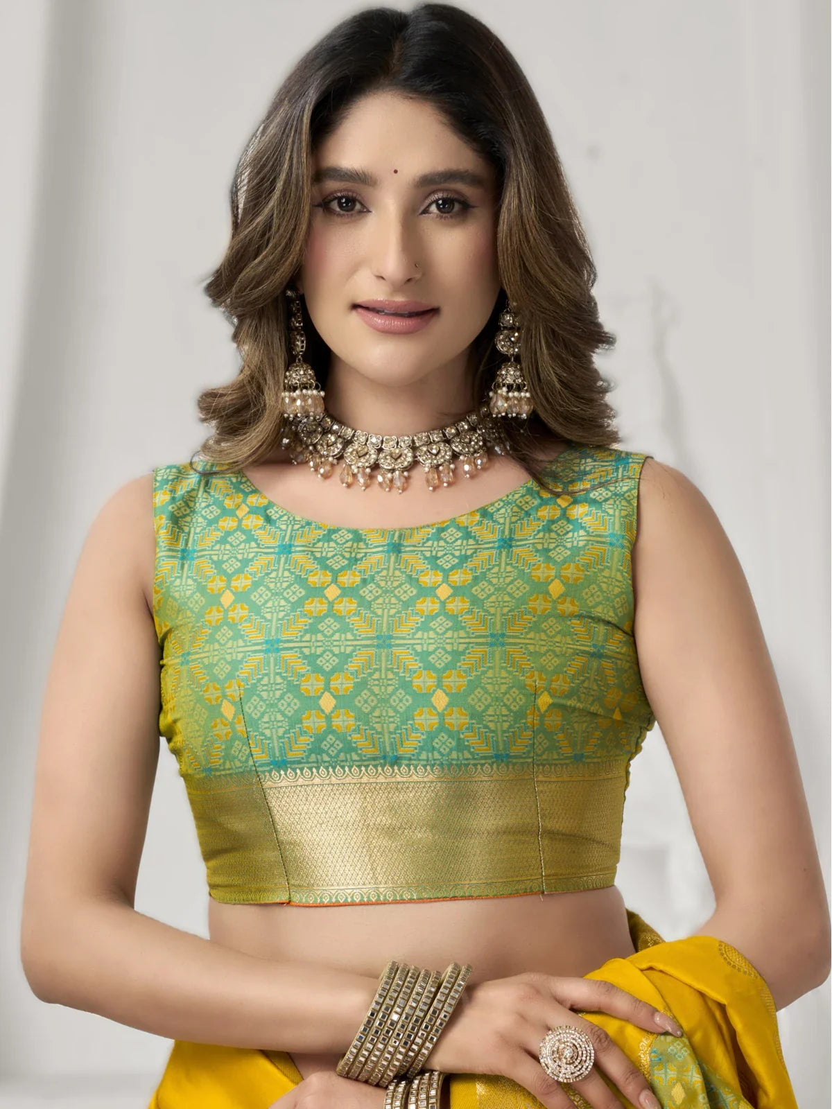 Tarani green silk blouse close-up paired with yellow soft silk saree