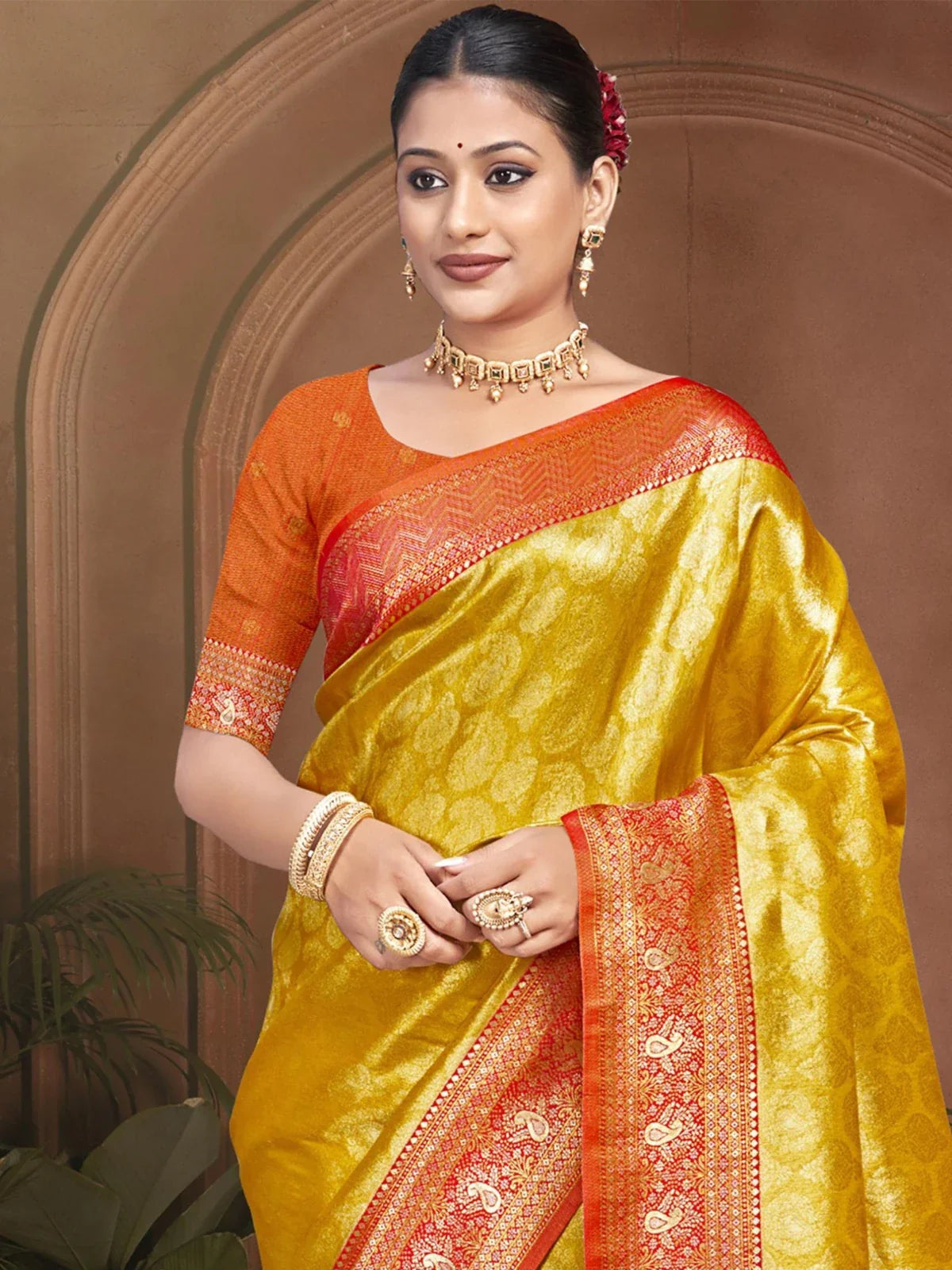 Tarani yellow Kanjivaram silk saree upper body view with red blouse and golden jewellery