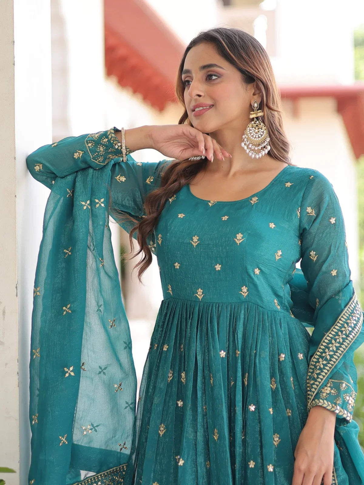 Tarani closeup of green silk gown neckline and sleeve sequin embroidery