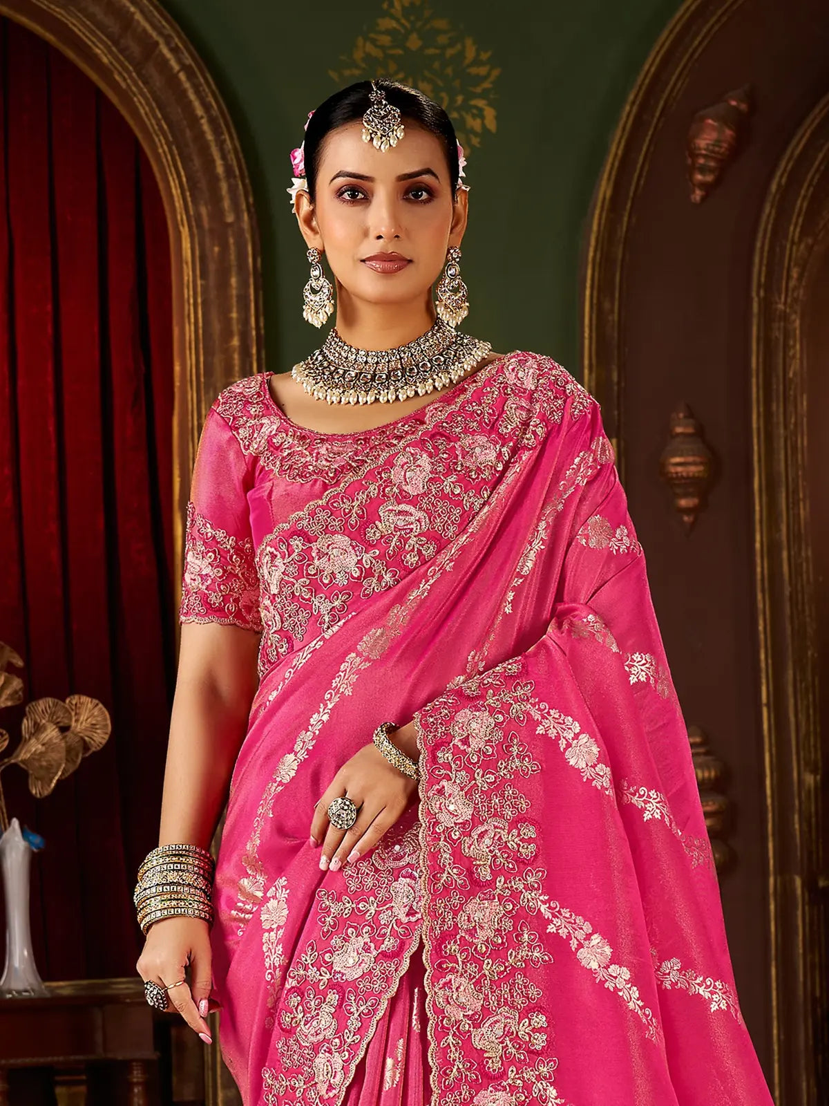 Tarani pink fancy saree upper body closeup showing floral embroidered blouse and jewelry styling