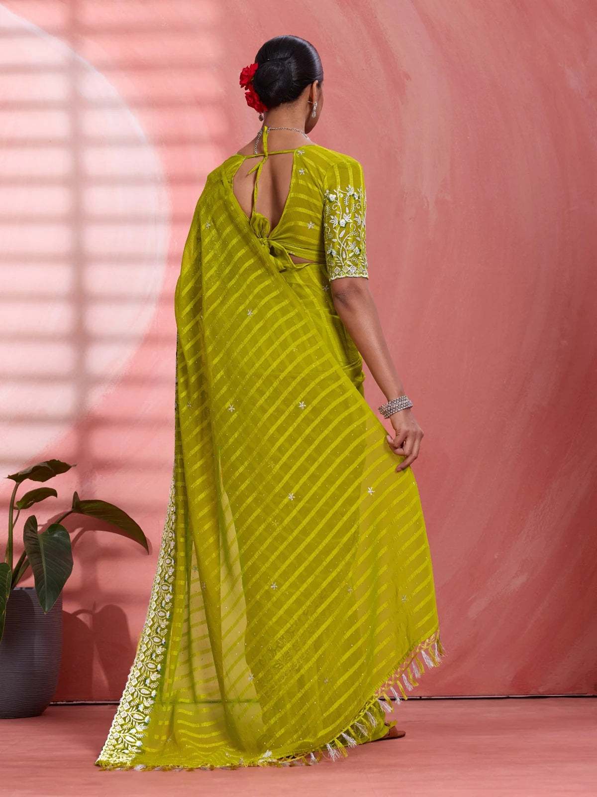 Tarani green solo chiffon saree back view with stylish blouse pattern and drape