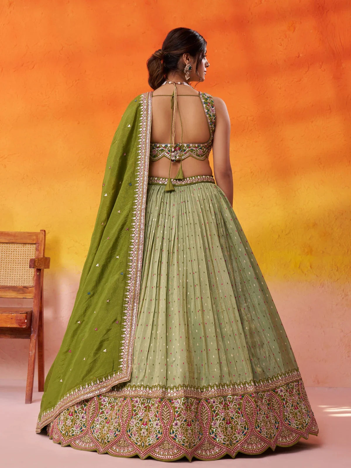 Tarani green jacquard tissue lehenga back view showing blouse back design and flowing skirt