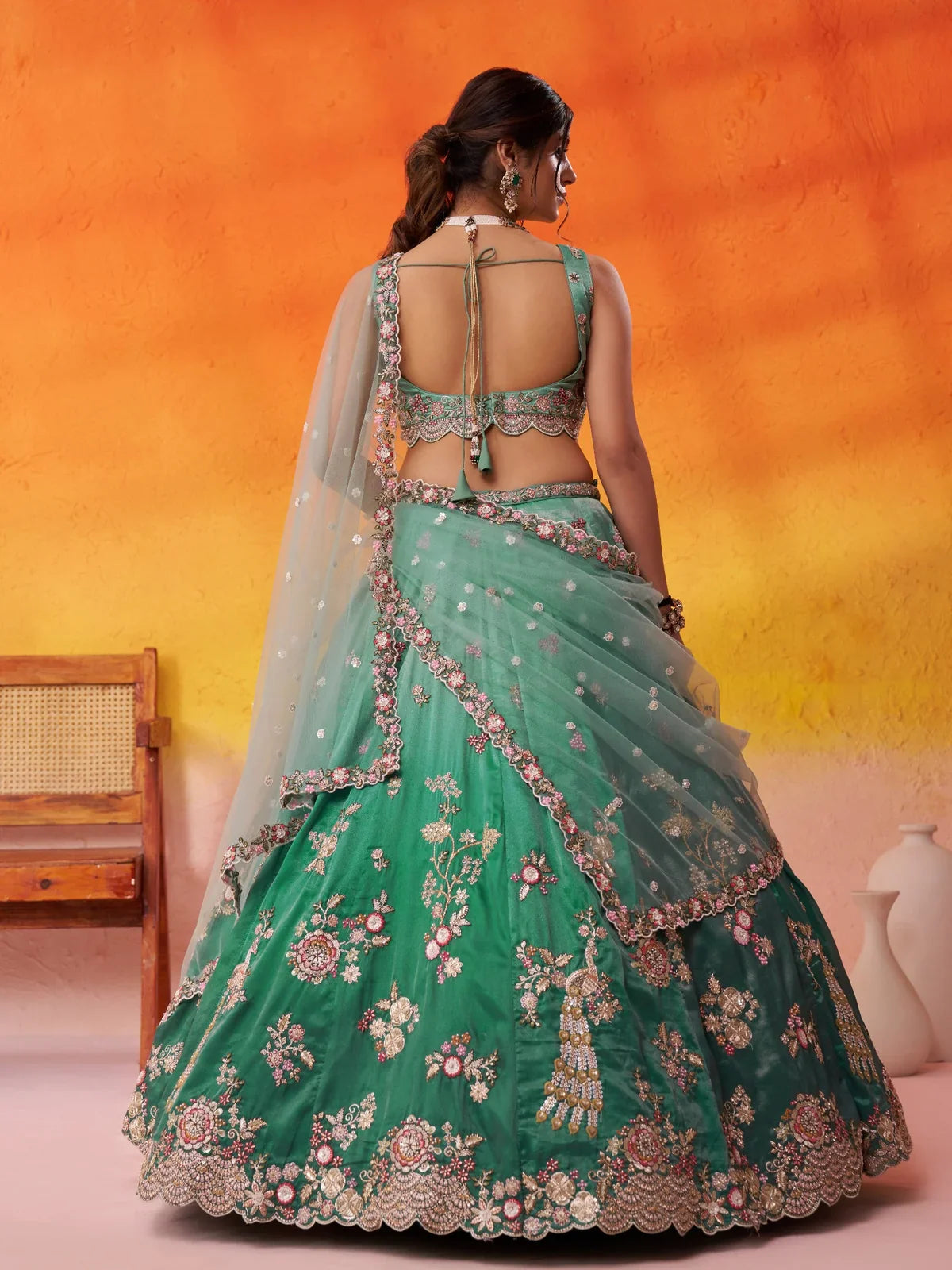 Tarani back view of tissue lehenga with blouse and dupatta styling in green