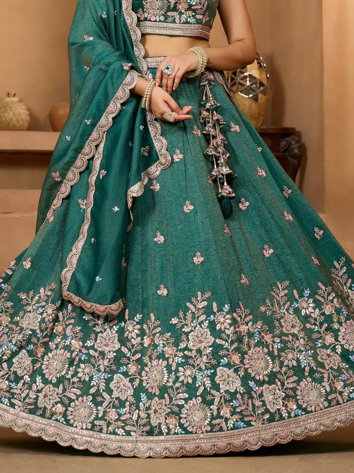 Tarani close-up of green tissue lehenga showcasing floral sequin embroidery and border work