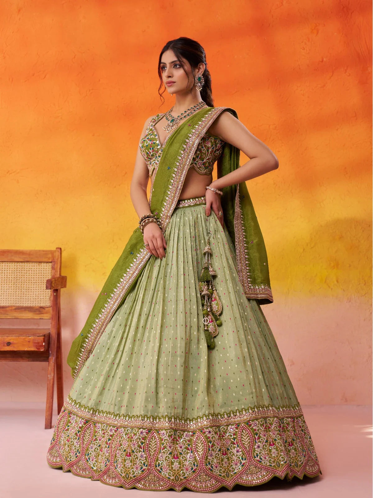 Tarani green jacquard tissue lehenga side view highlighting graceful flare and tassel details