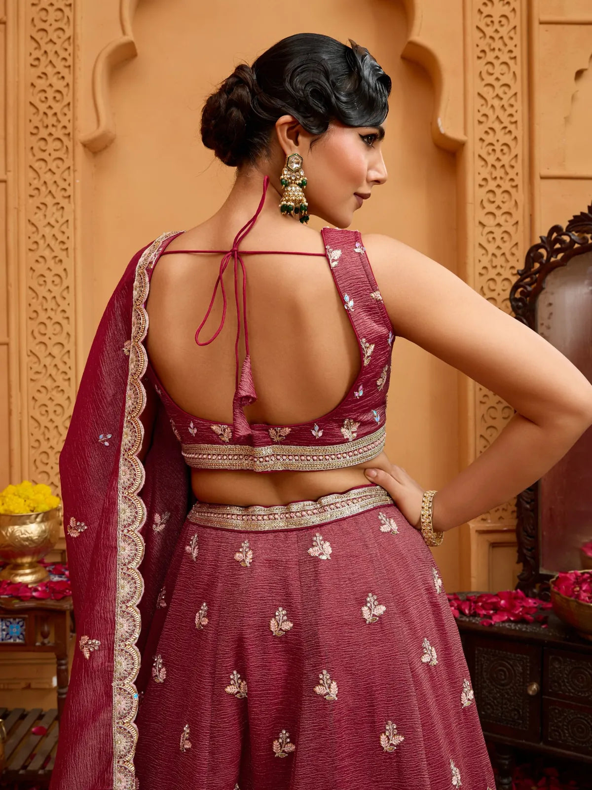Tarani maroon tissue lehenga back view showing tie-up blouse design and detailed work