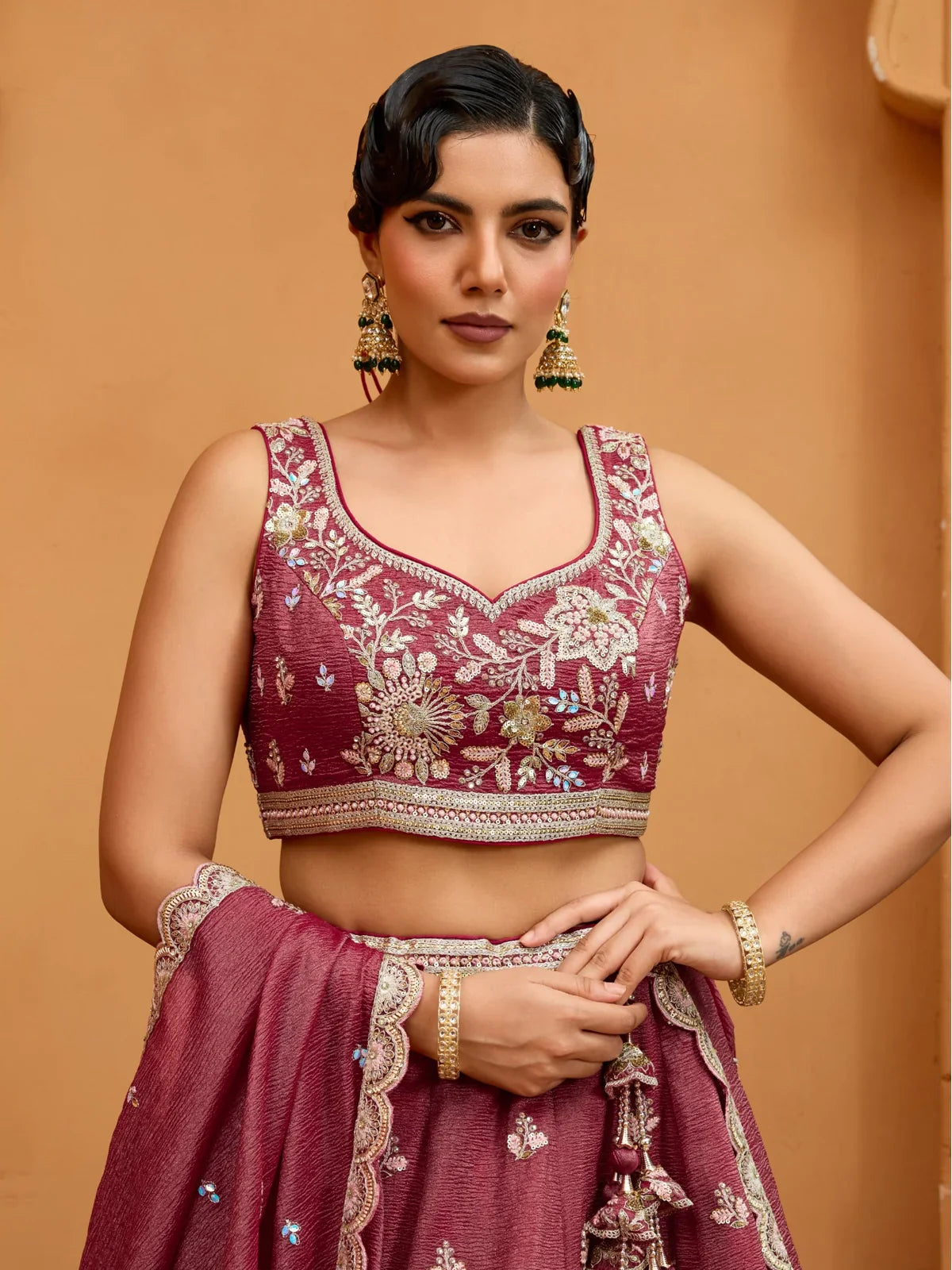 Tarani maroon tissue lehenga blouse upper body view with detailed embroidery and elegant neckline