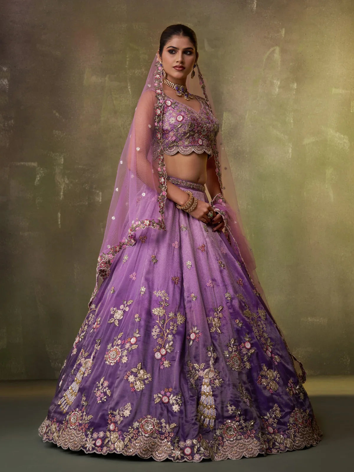 Tarani purple lehenga side pose showing elegant flow and floral embroidery in tissue fabric