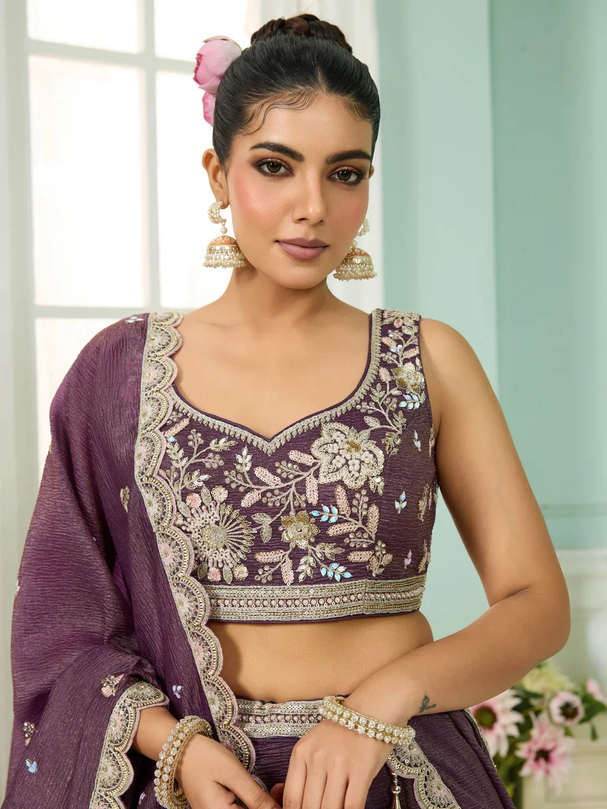 Tarani purple tissue lehenga blouse upper body view with floral embroidery and jhumka styling