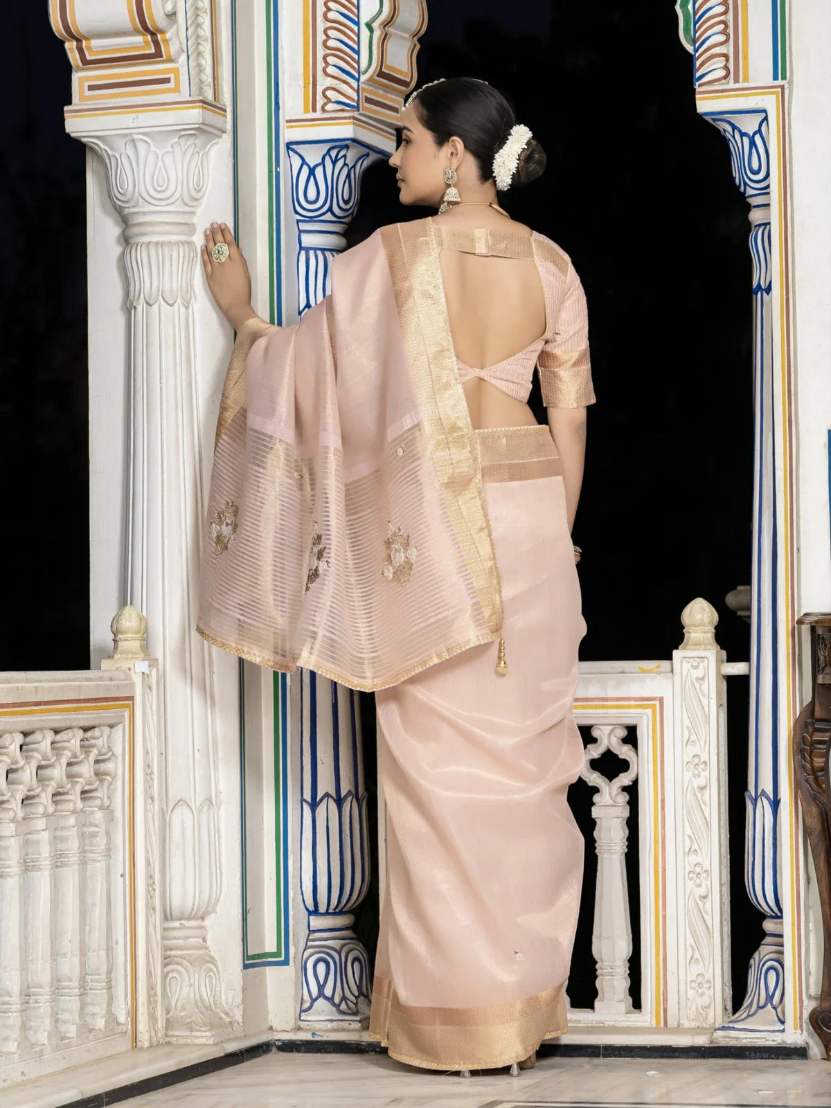 Tarani peach tissue linen saree back view showing zari patta and elegant drape