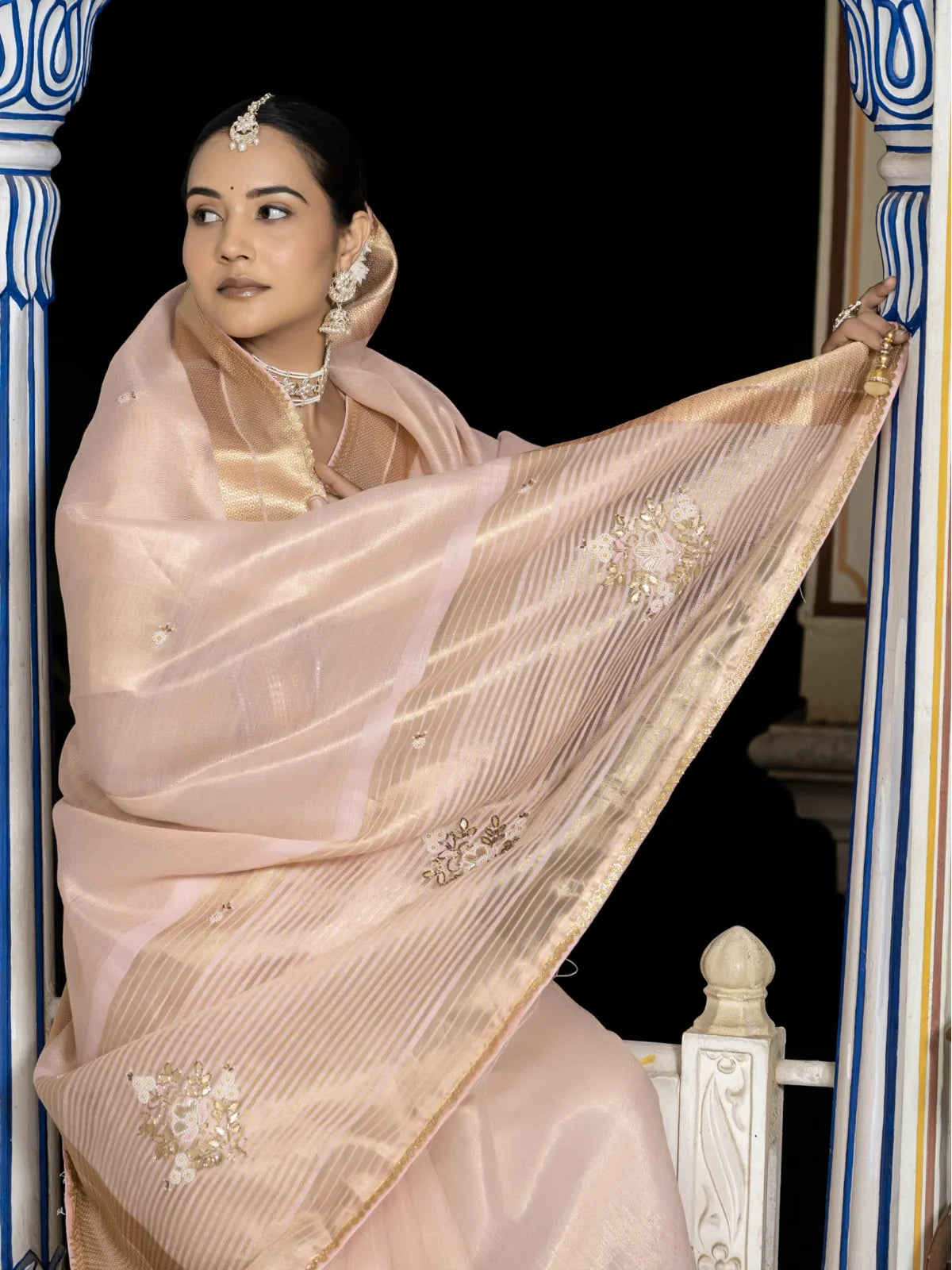 Tarani peach tissue linen saree pallu view with zari and hand embroidery work