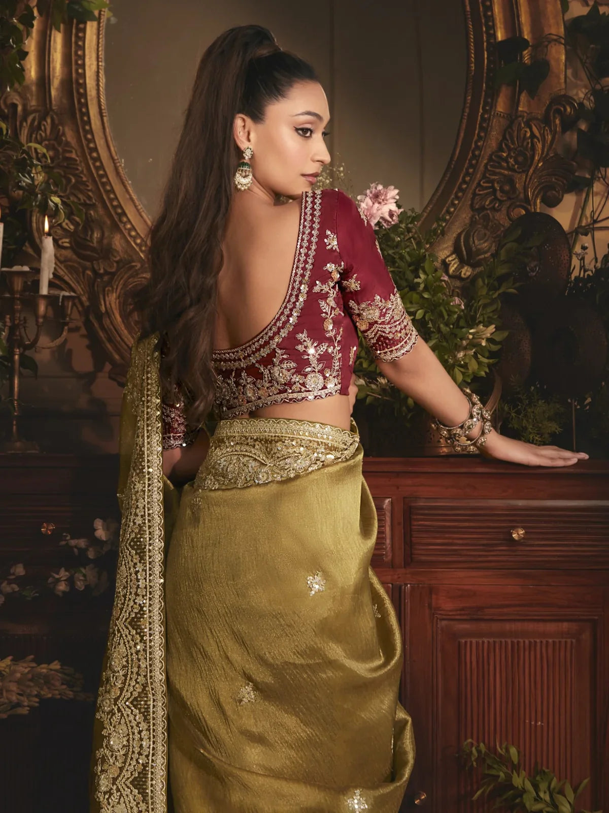 Tarani green saree back blouse view with intricate embroidery and deep neckline