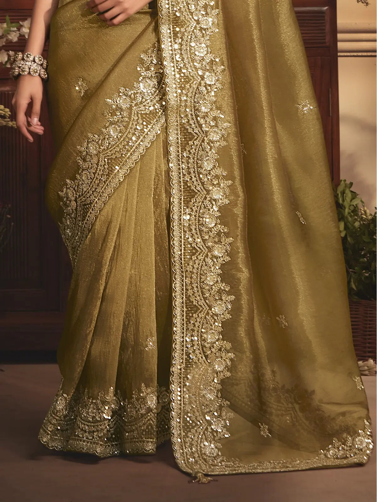 Tarani green saree pallu view with heavy embroidered border and shimmering fabric