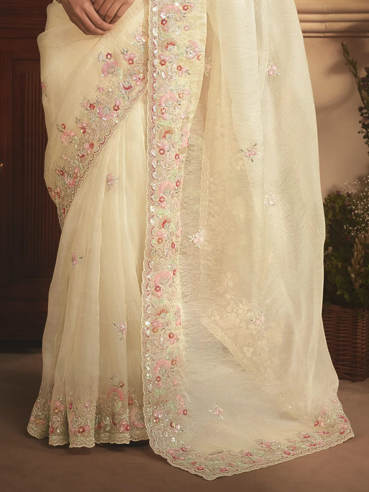 Tarani detailed off white tissue organza saree pallu and border close view with floral embroidery and stone work