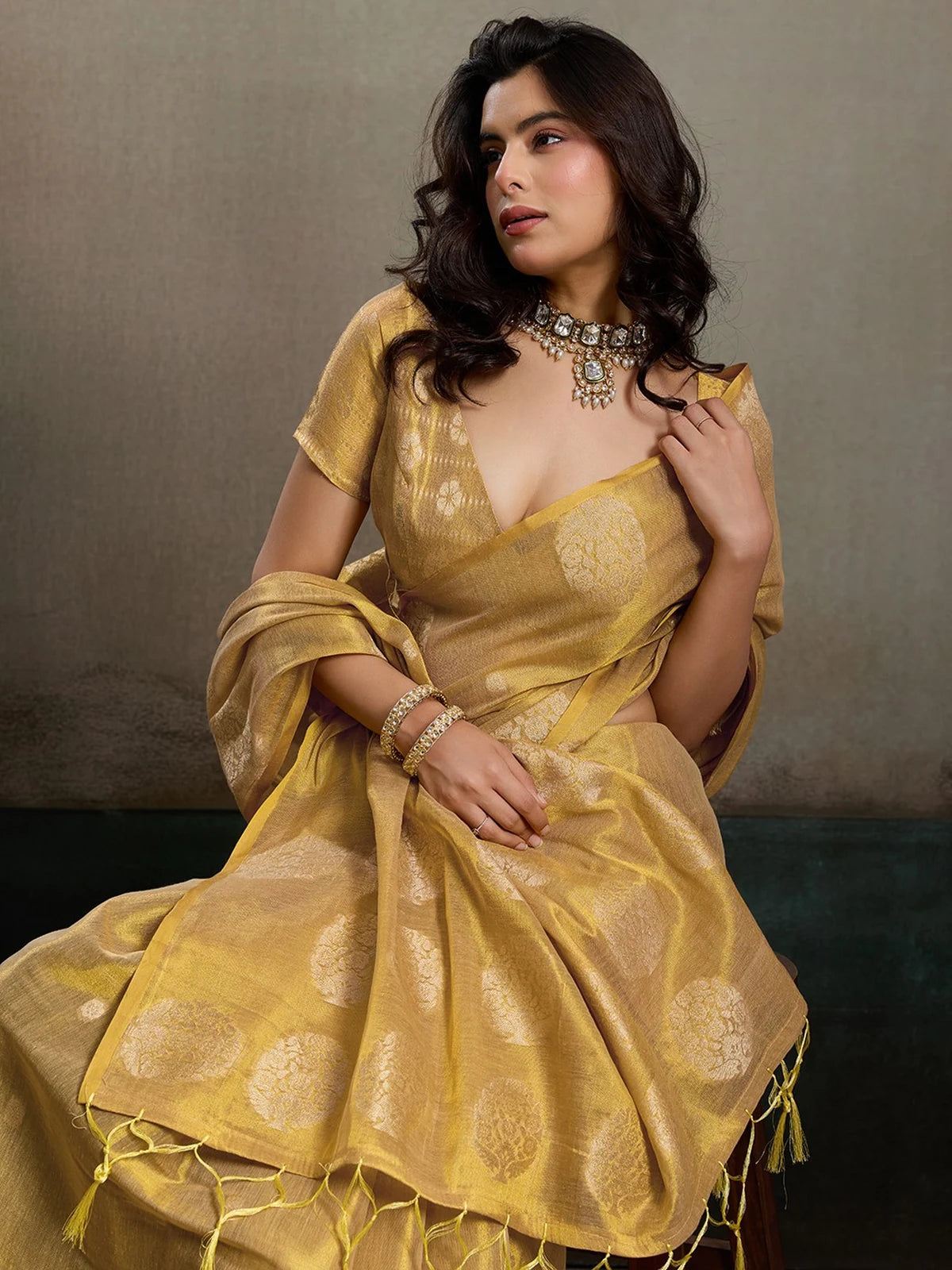 Tarani Samaira golden tissue silk saree closeup view showcasing rich texture and woven motifs